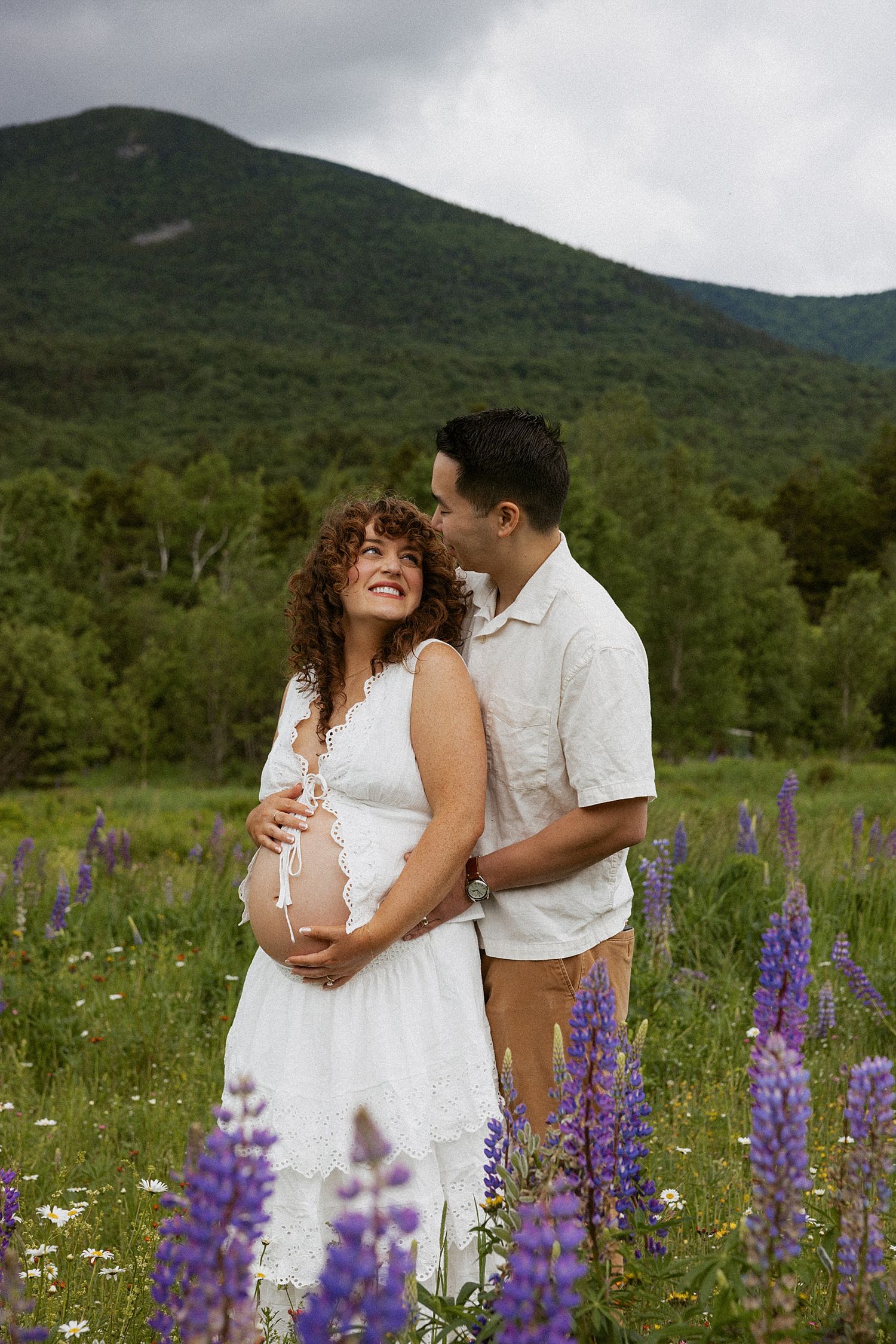 New Hampshire couple taking maternity photos in a field in the White Mountains