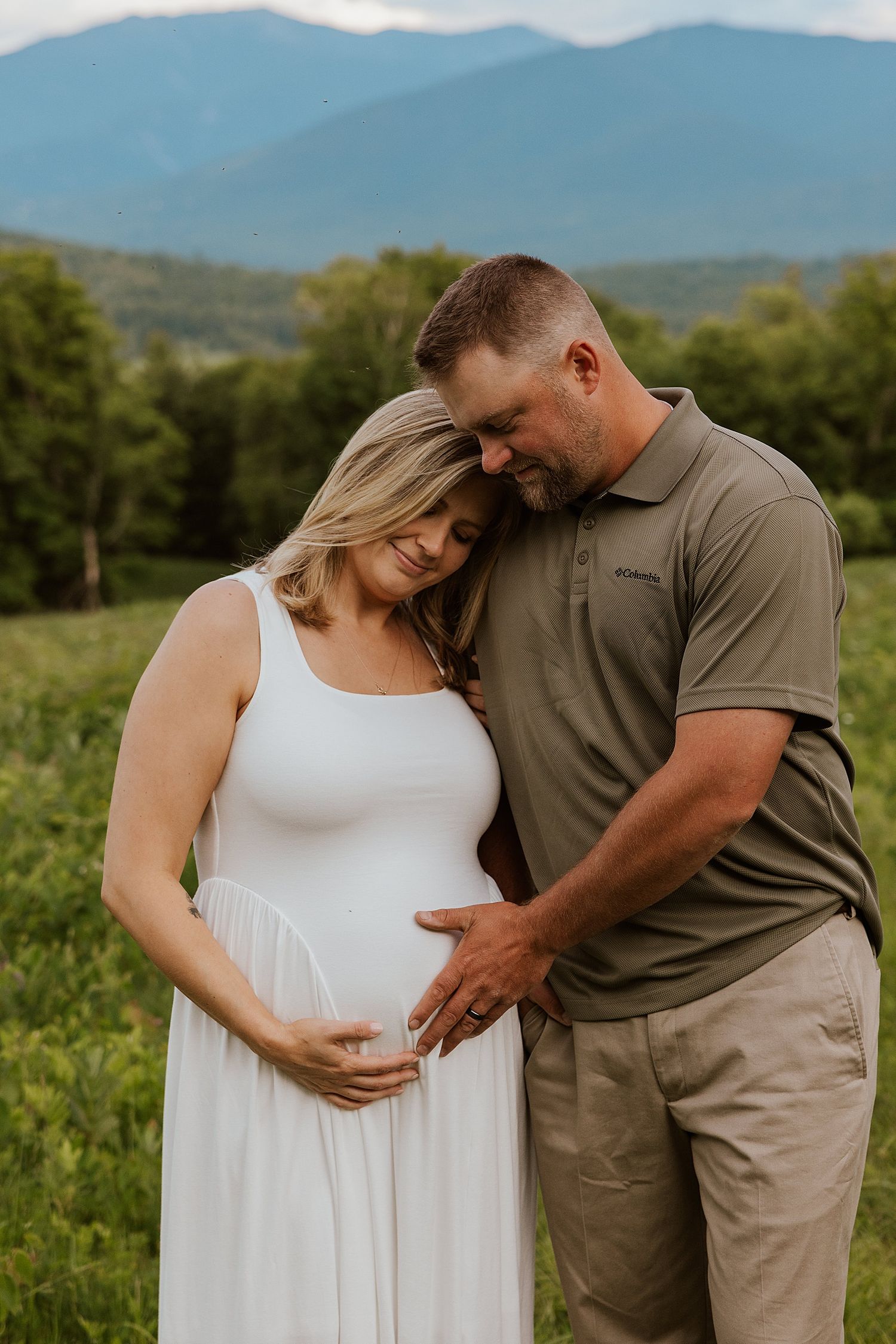 Couple taking maternity photos in the NH White Mountains