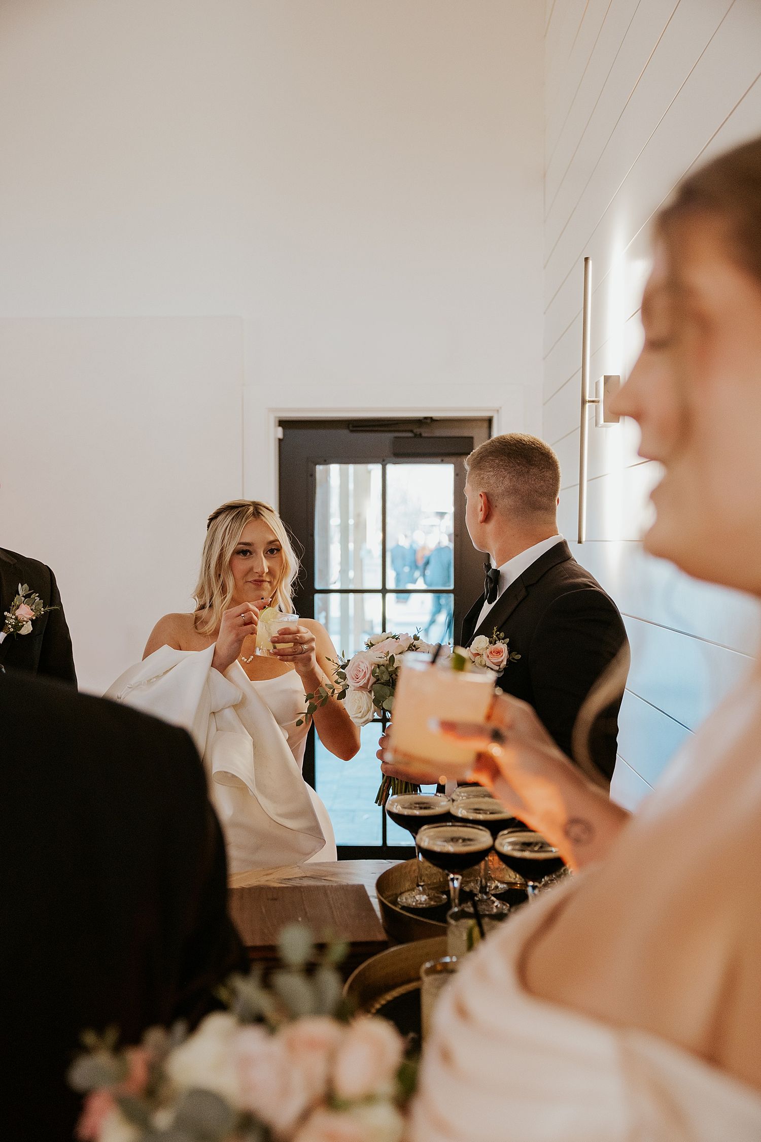Bride and groom having a drink after their wedding ceremony at Hyla Brook Estate