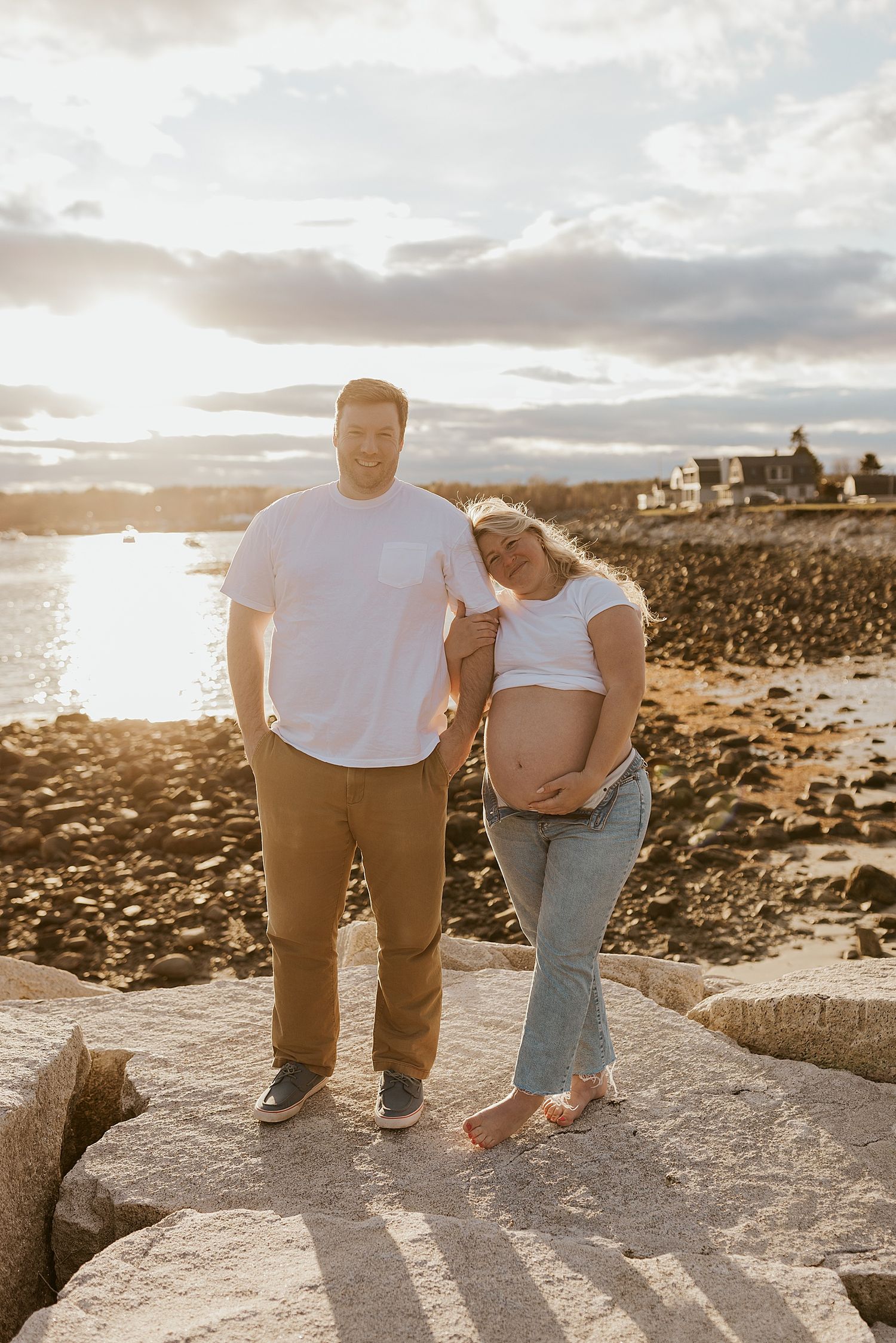 Couple doing a maternity New Hampshire photoshoot at the beach