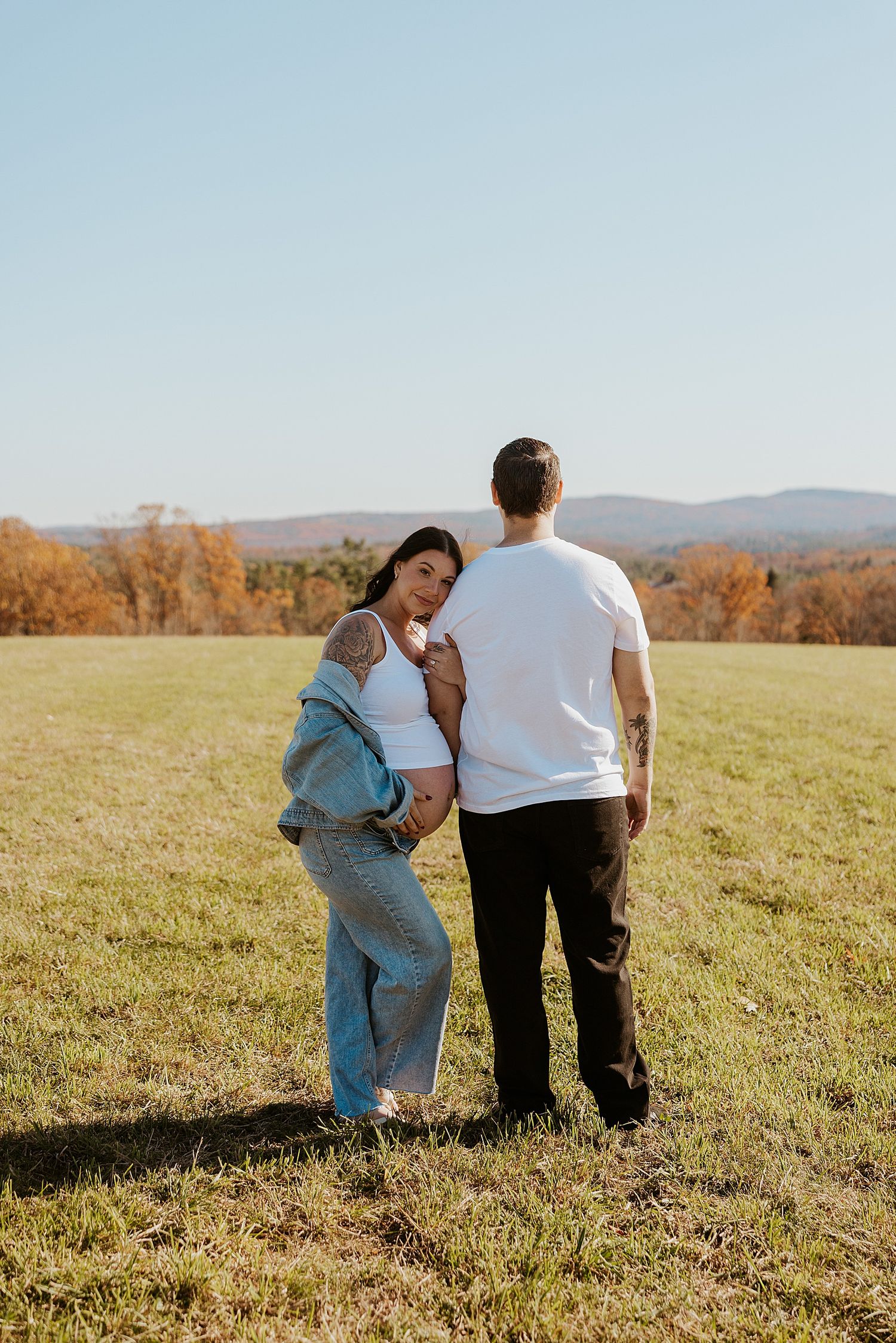 Couple taking maternity photos in New Hampshire