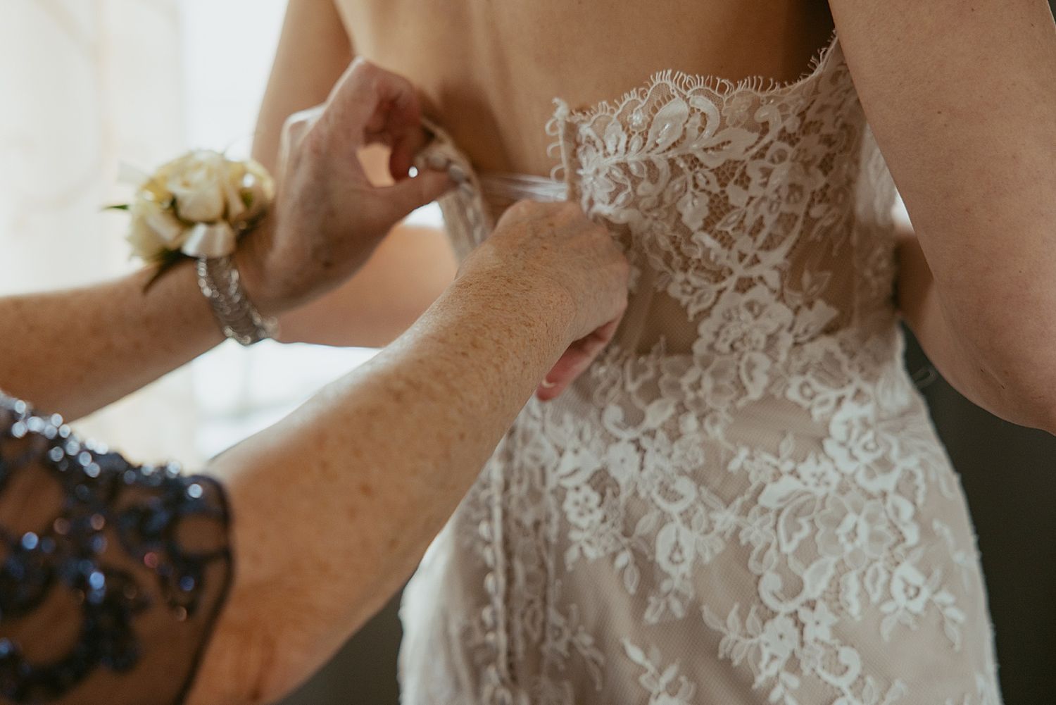 Bride getting into her dress for her NH mirco wedding