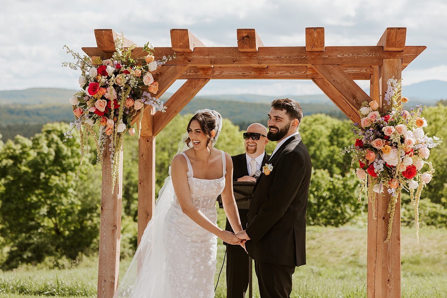 Bride and groom laughing at their wedding ceremony at Longlook Farm in NH