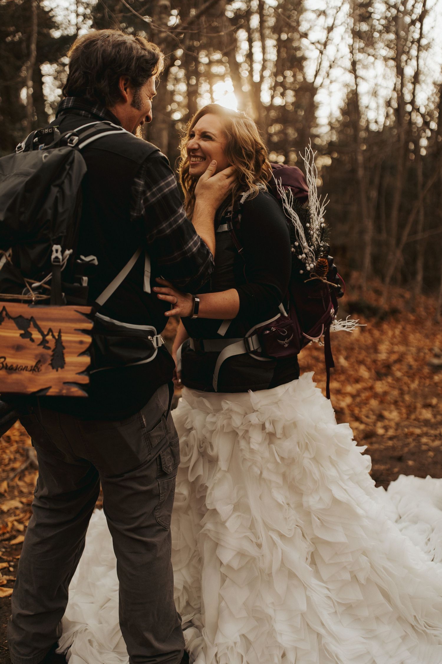 Jackie and Andy Brosonski hike the West Ridge Trail on Mount Cardigan in their wedding attire