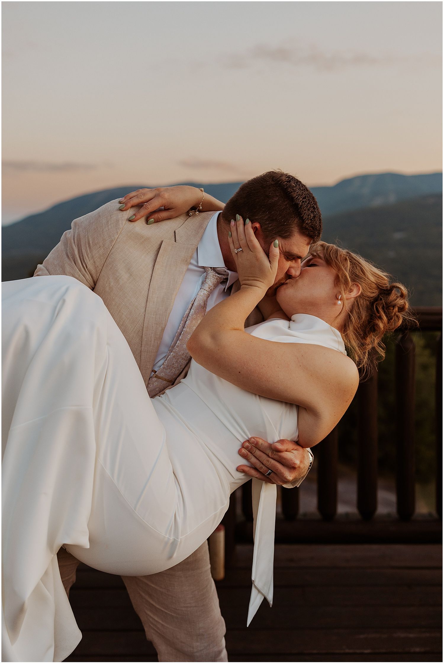 Bride and groom taking sunset photos at their Maine wedding in the mountains