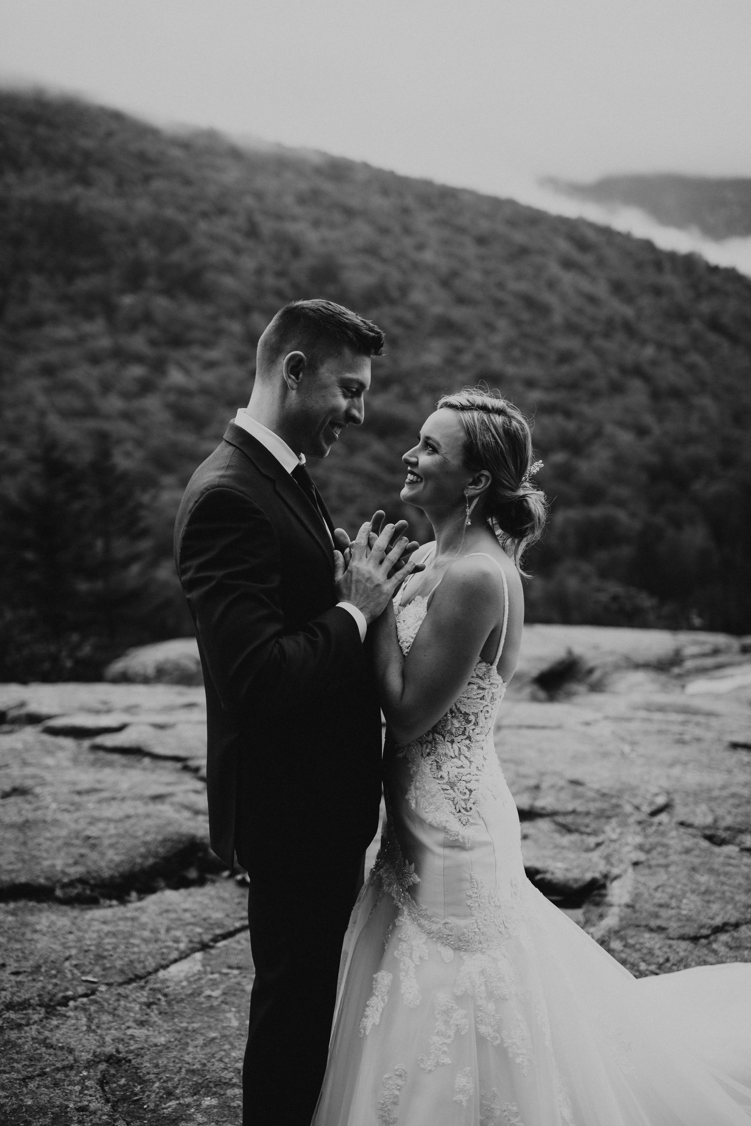 Newlyweds posing for mountaintop portraits in the White Mountain National Forest of New Hampshire.
