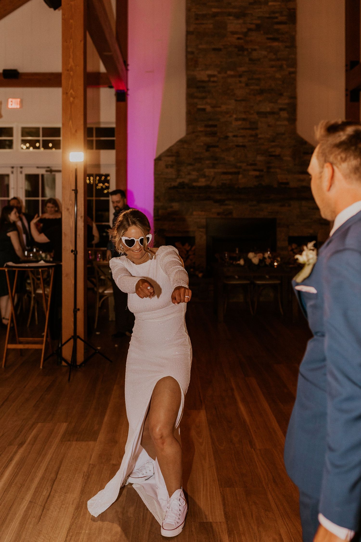 The bride reeling in the groom for some dance floor fun at their wedding reception in Thornton, New Hampshire.