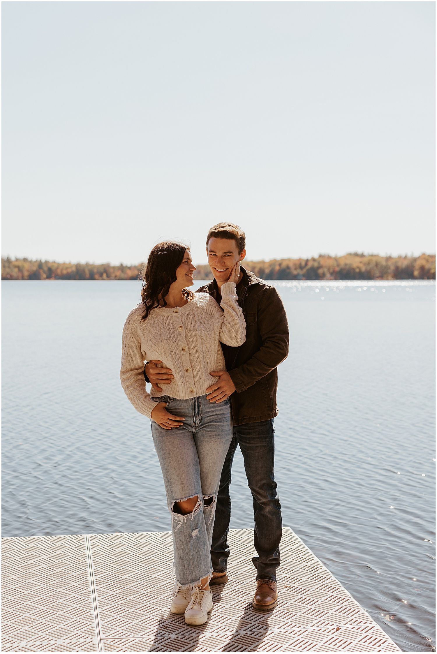 NH couple taking engagement photos by the lake by Robin Easler Photography