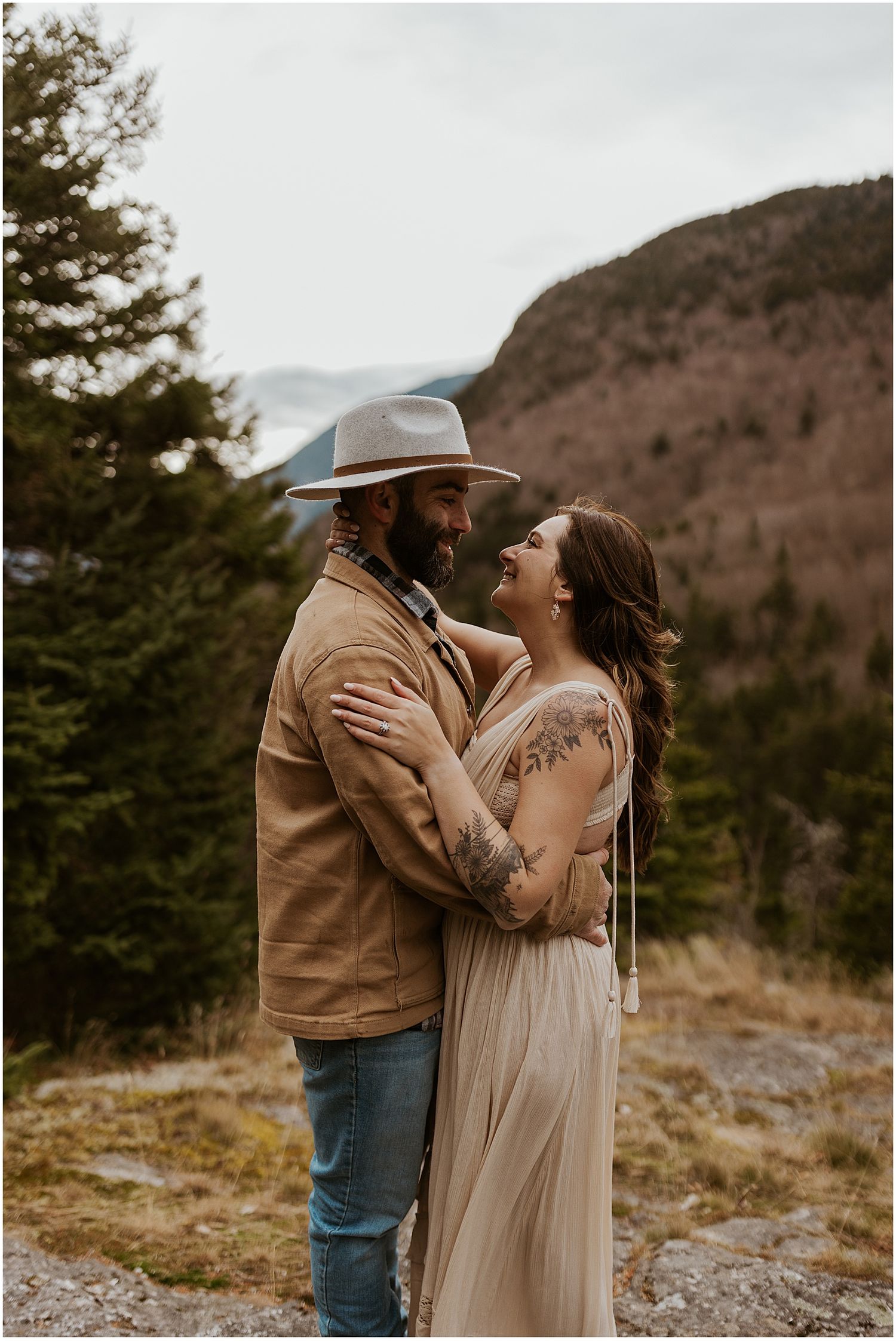 Boho couple taking engagement photos in the NH White Mountains