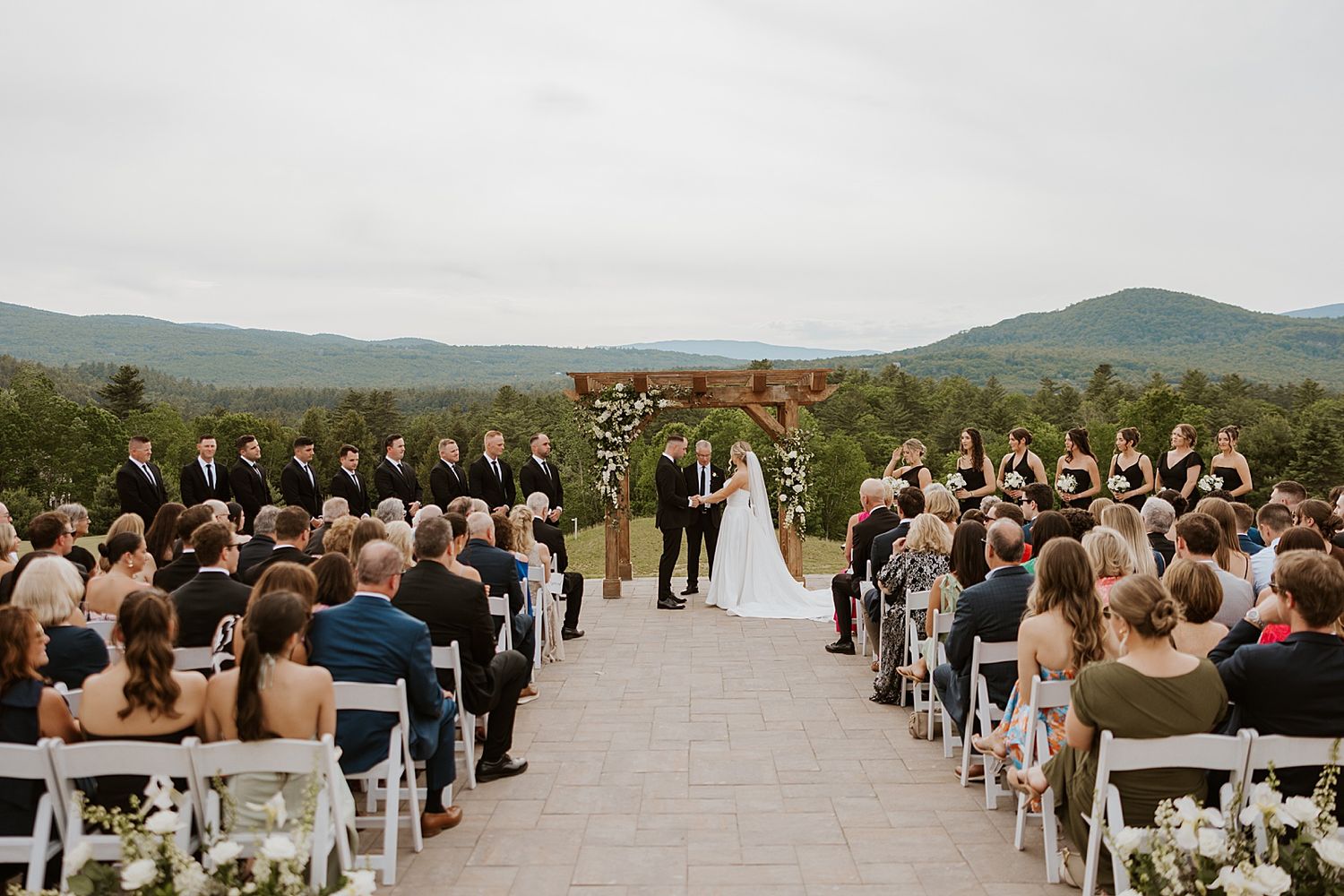 An outdoor wedding ceremony overlooking the mountains at the Owl's Nest Resort in NH