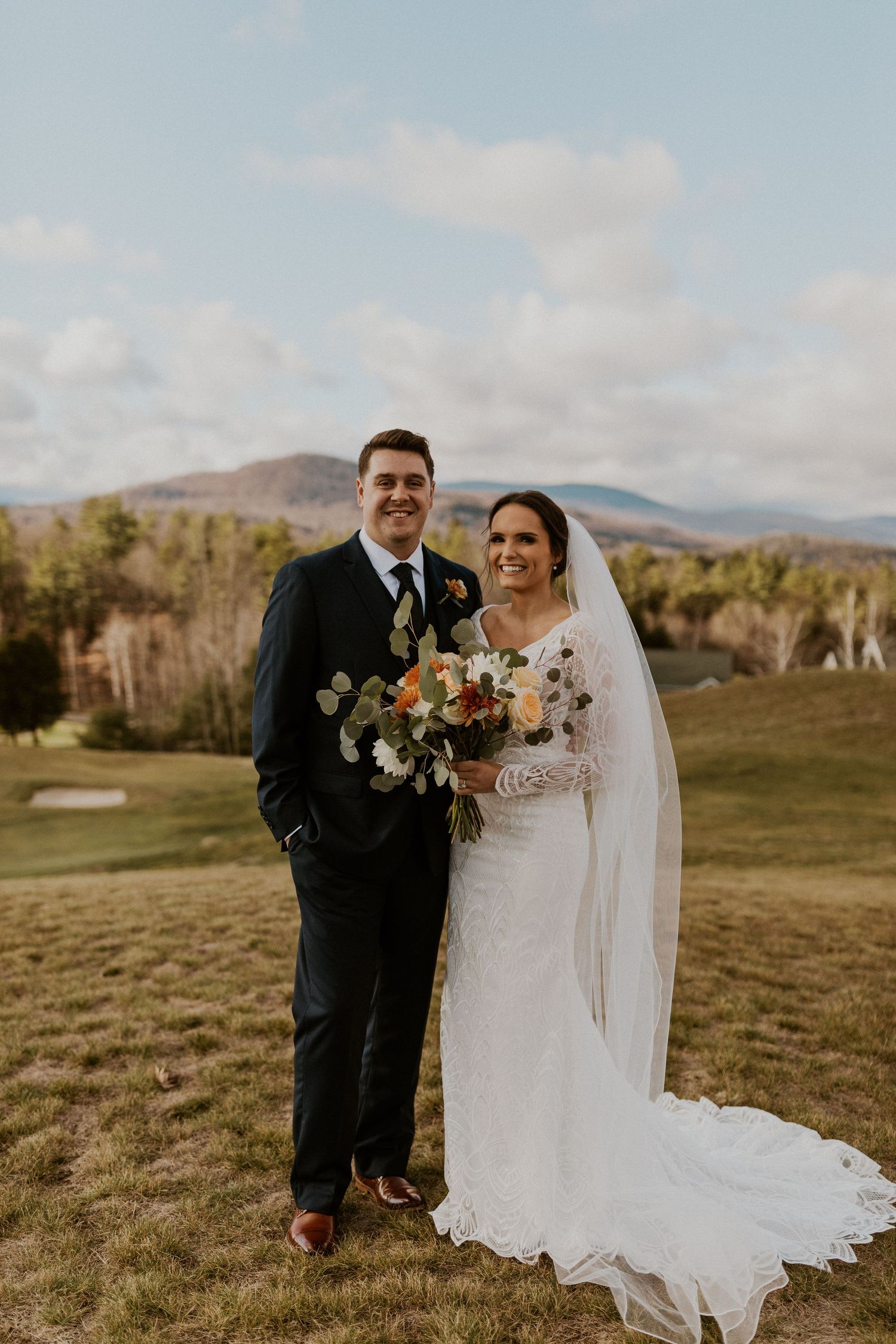 A portrait of the bride and groom with the stunning mountain backdrop at Owl's Nest Resort in Thornton, New Hampshire.