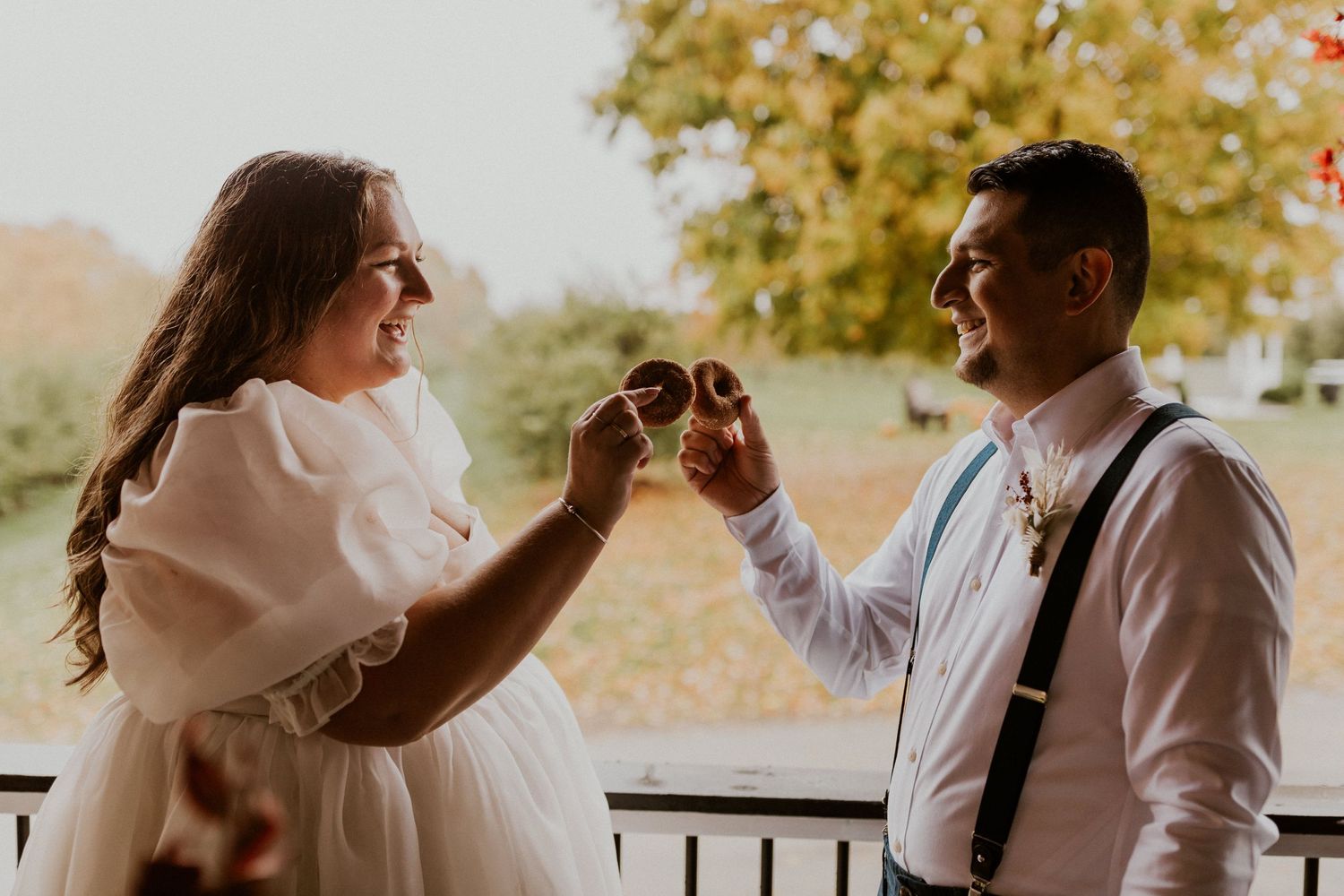 Terise and Jose sharing a donut at Carter Hill Orchard in Concord New Hampshire.