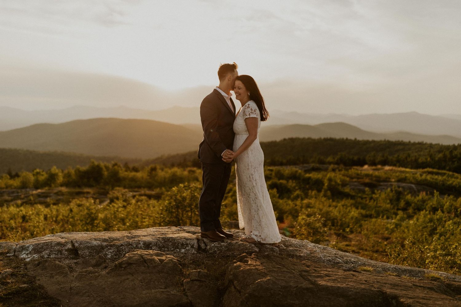 Danielle and Colin dressed in their wedding attire for their one year anniversary photoshoot on Foss Mountain in NH.