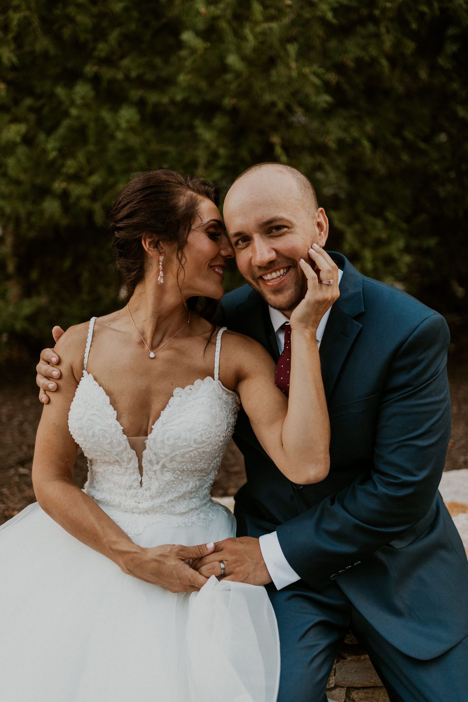 Romantic wedding couple shares intimate moment during outdoor portrait session.