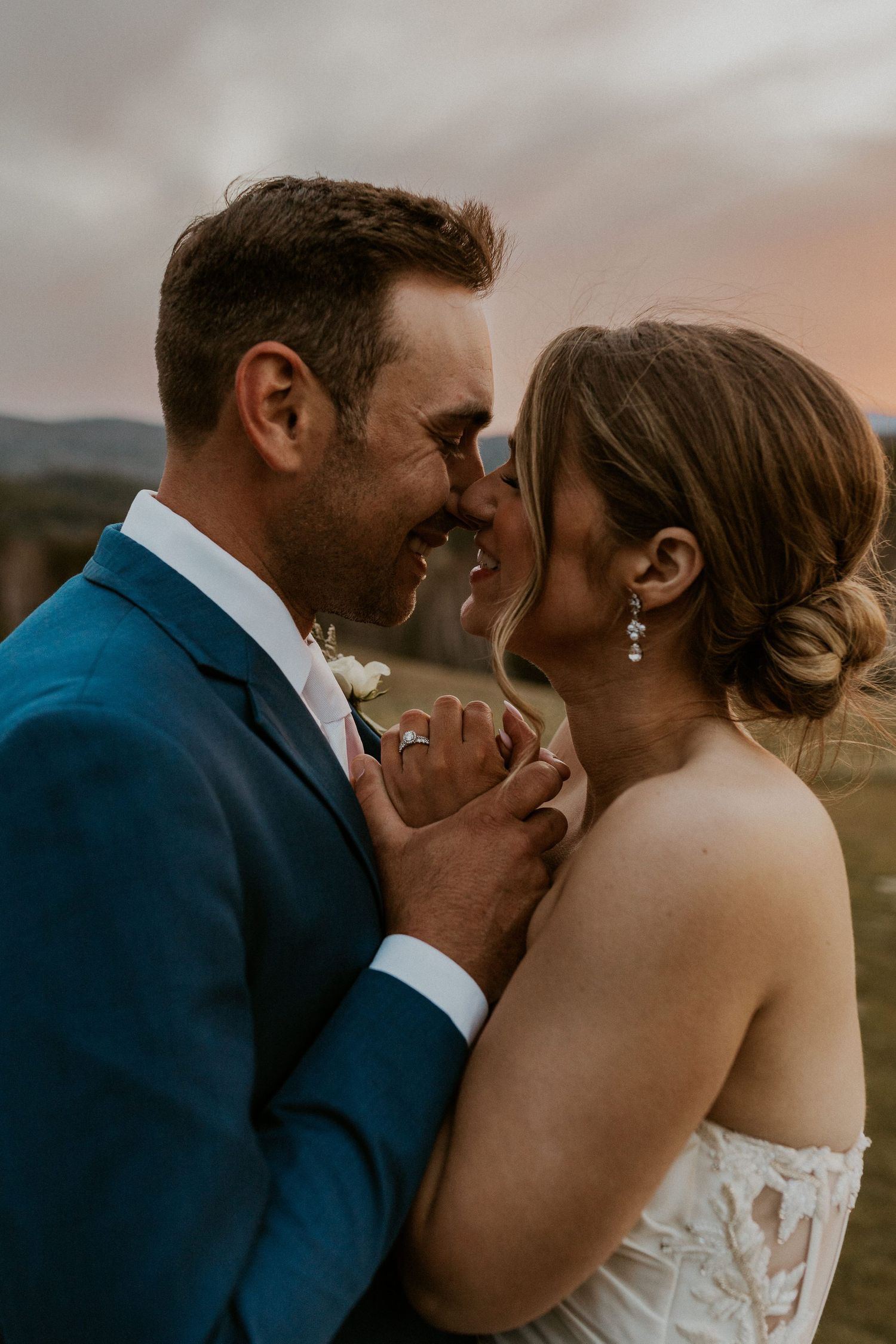 Kendra and Andrew snuggling up intimately together during sunset at Owl's Nest Resort in Thornton NH.