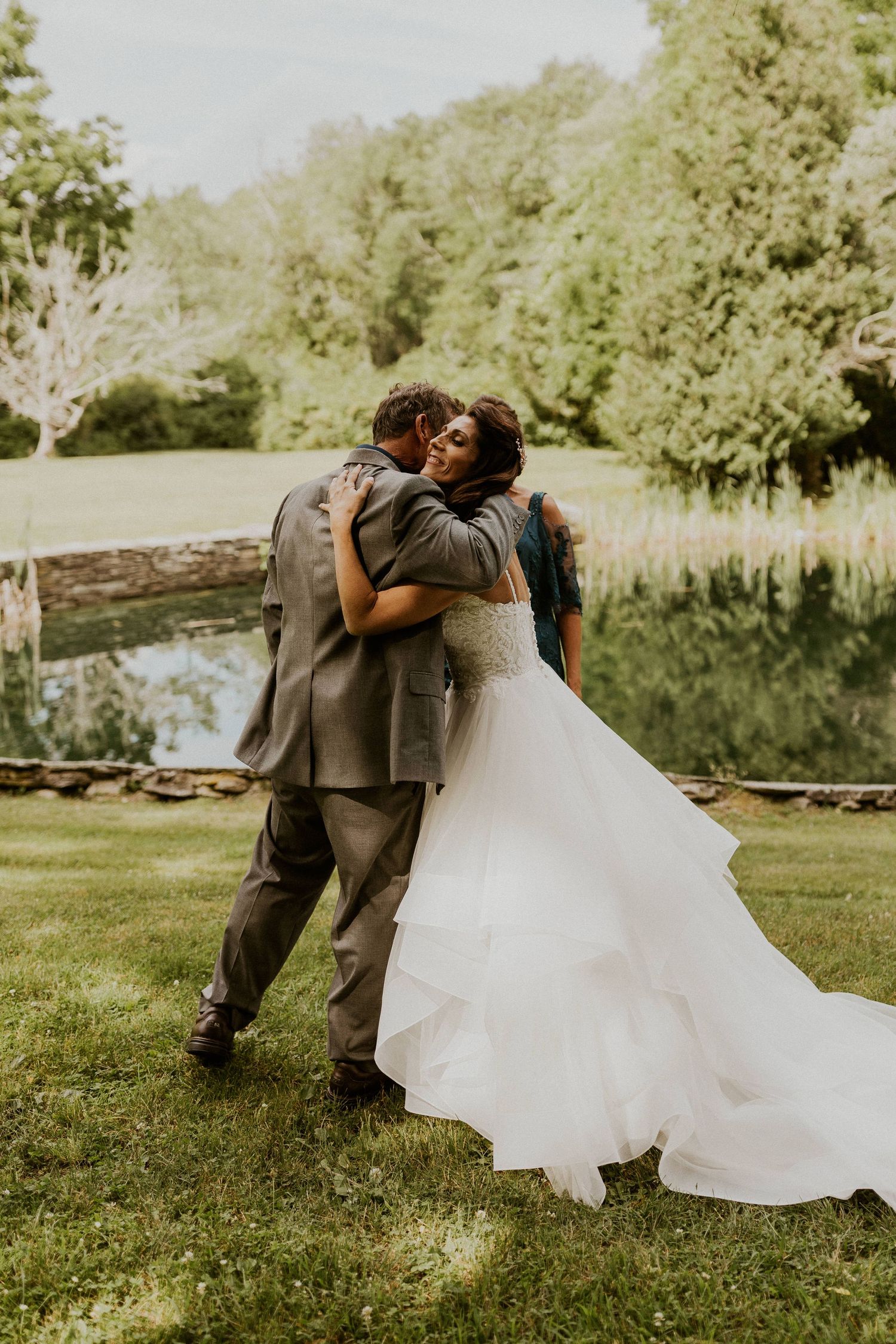 Jessica sharing a special moment with her parents, revealing her wedding gown.
