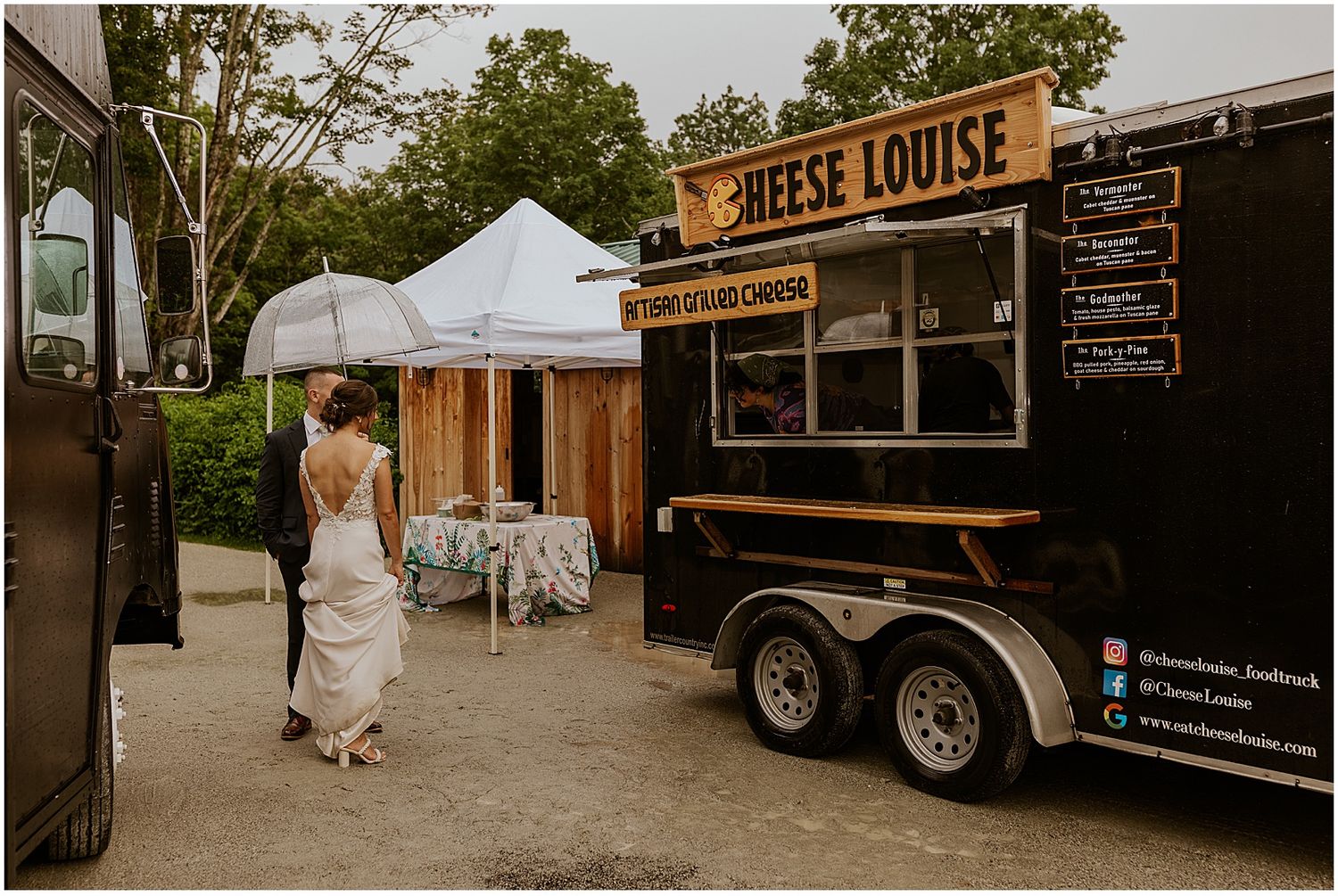 Food trucks parked at outdoor wedding venue providing catering services.