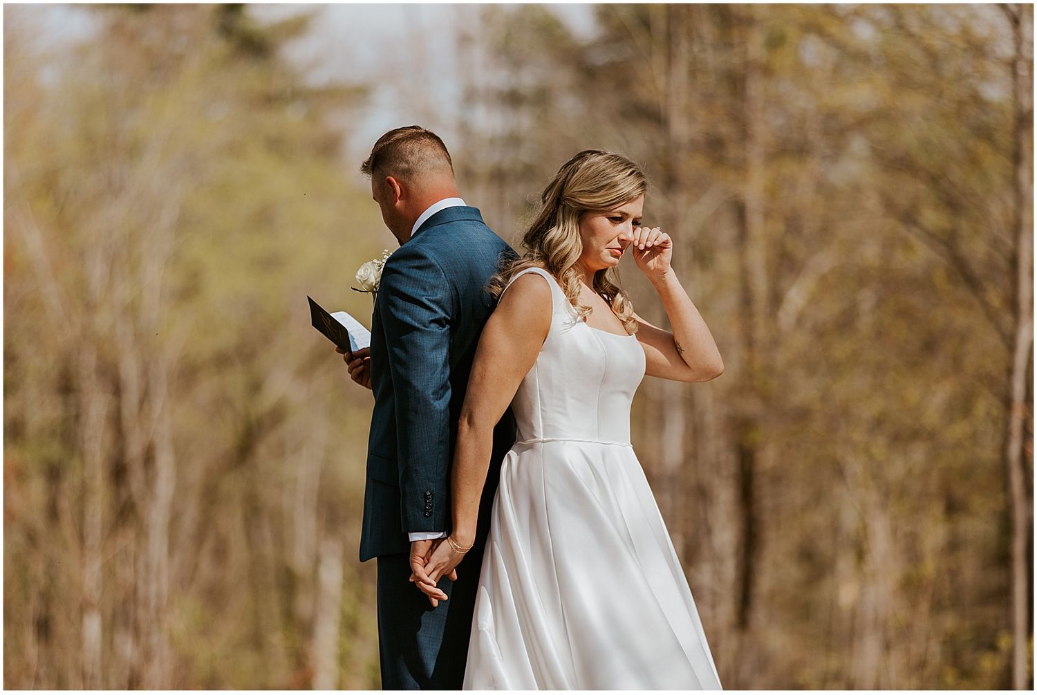 A couple shares an intimate moment in a rustic outdoor setting.