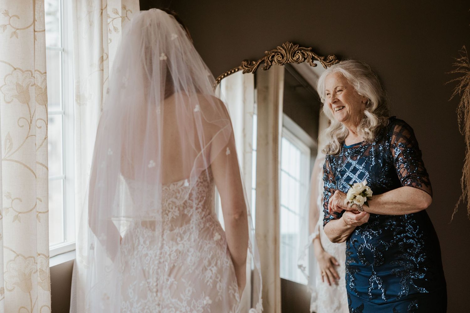 A collection of wedding dresses on display in a bridal boutique with natural light streaming through windows.