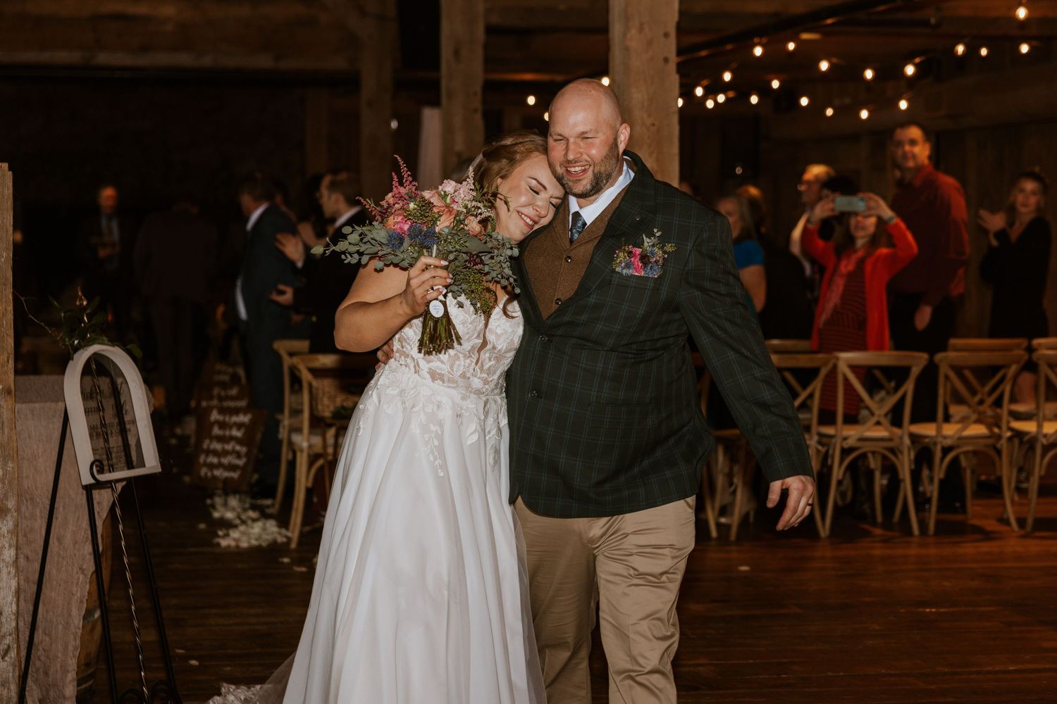 Couples dance together at an evening wedding reception under warm lighting.