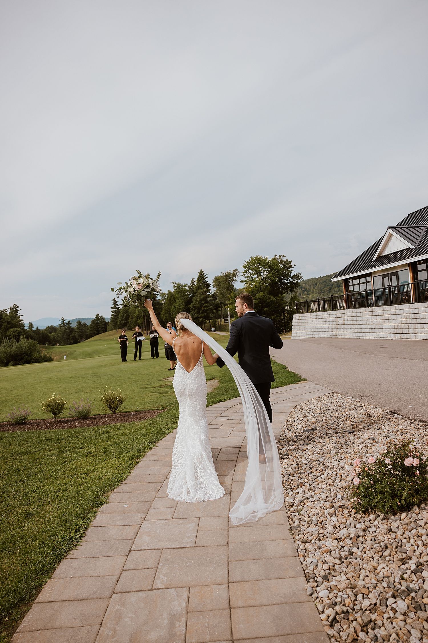 Bride and groom walking away after their wedding ceremony at the Owl's Nest Resort in NH