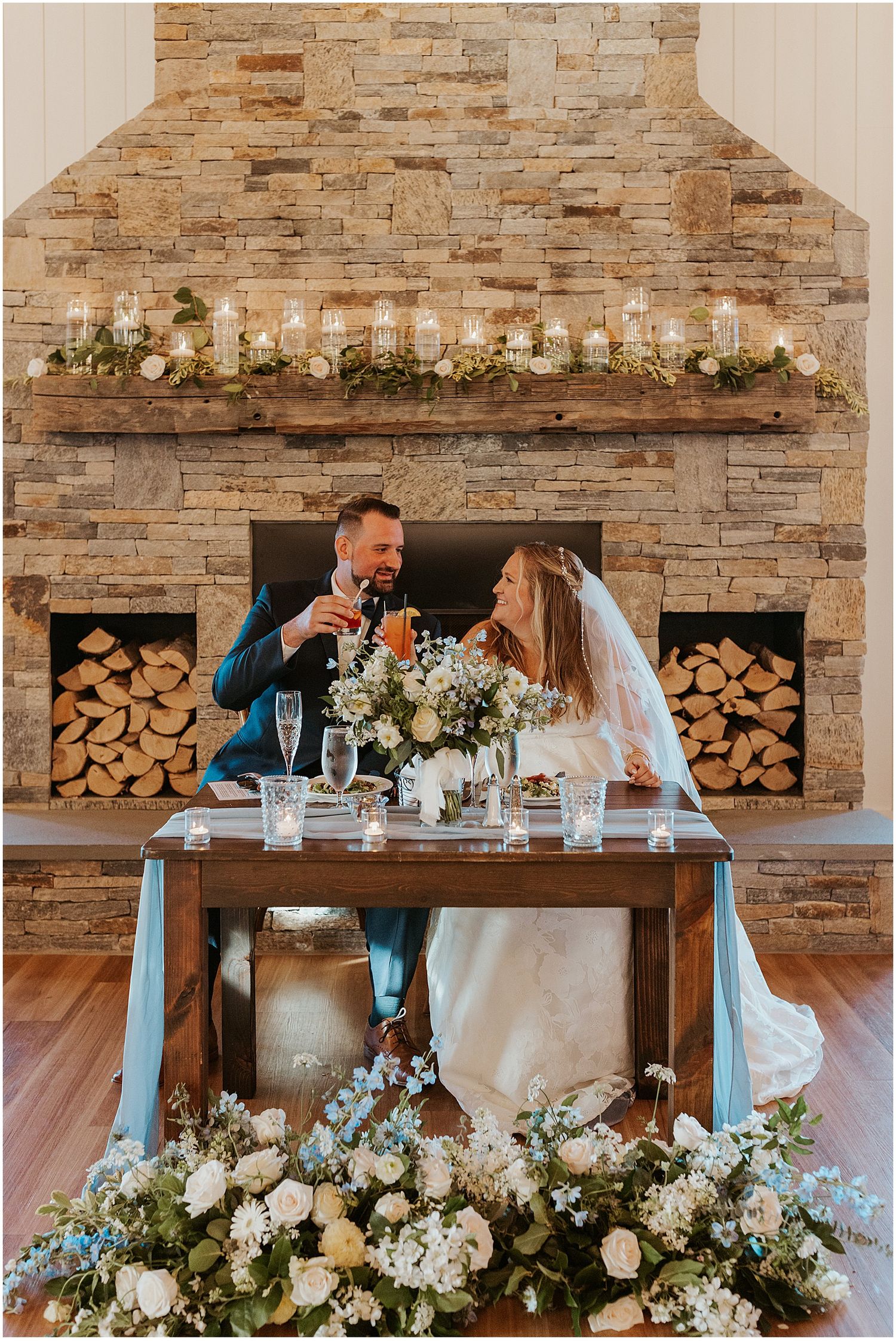 Bride and groom at the sweetheart table at their Ow'ls Nest wedding