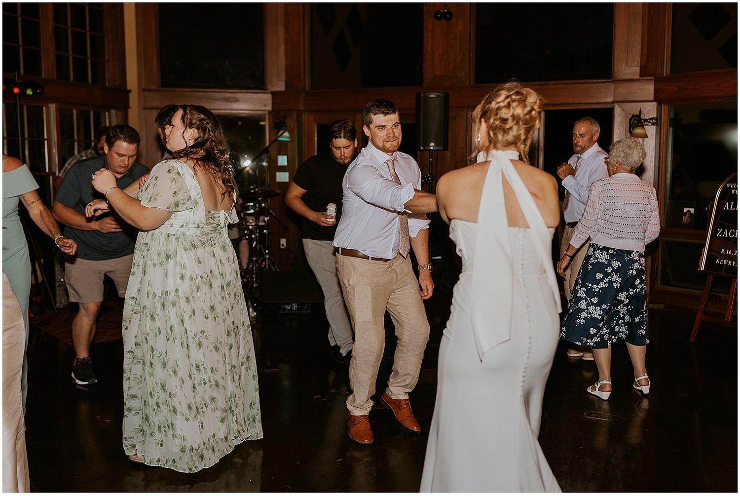 Bride dancing with wedding guests at her Maine wedding at a VRBO in the mountains