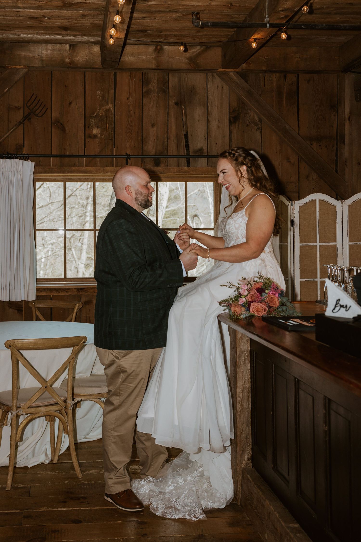 Intimate dance moment captured in a rustic wooden barn venue with natural light streaming through windows.