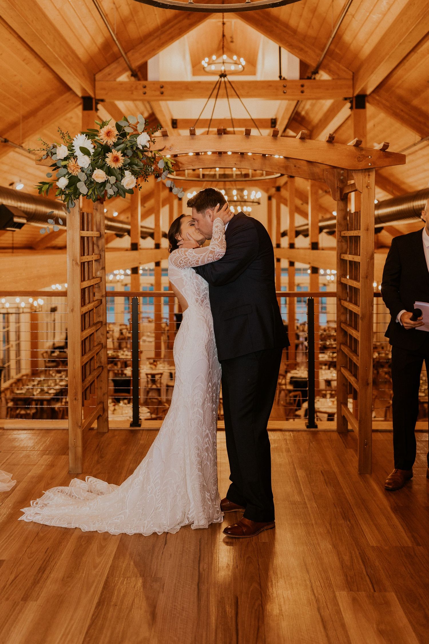 Bride and groom sharing their first kiss in the new Lake House at Owl's Nest Resort in Thornton NH