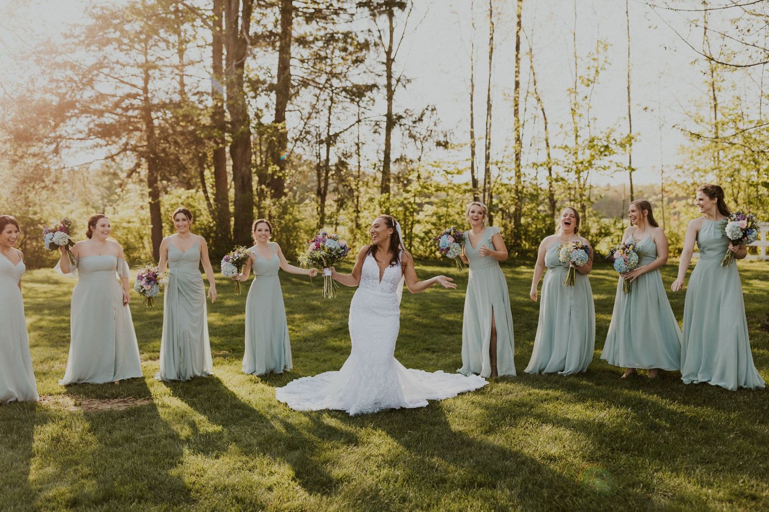 A fun and playful bridesmaid photo with the sun shining in the background.