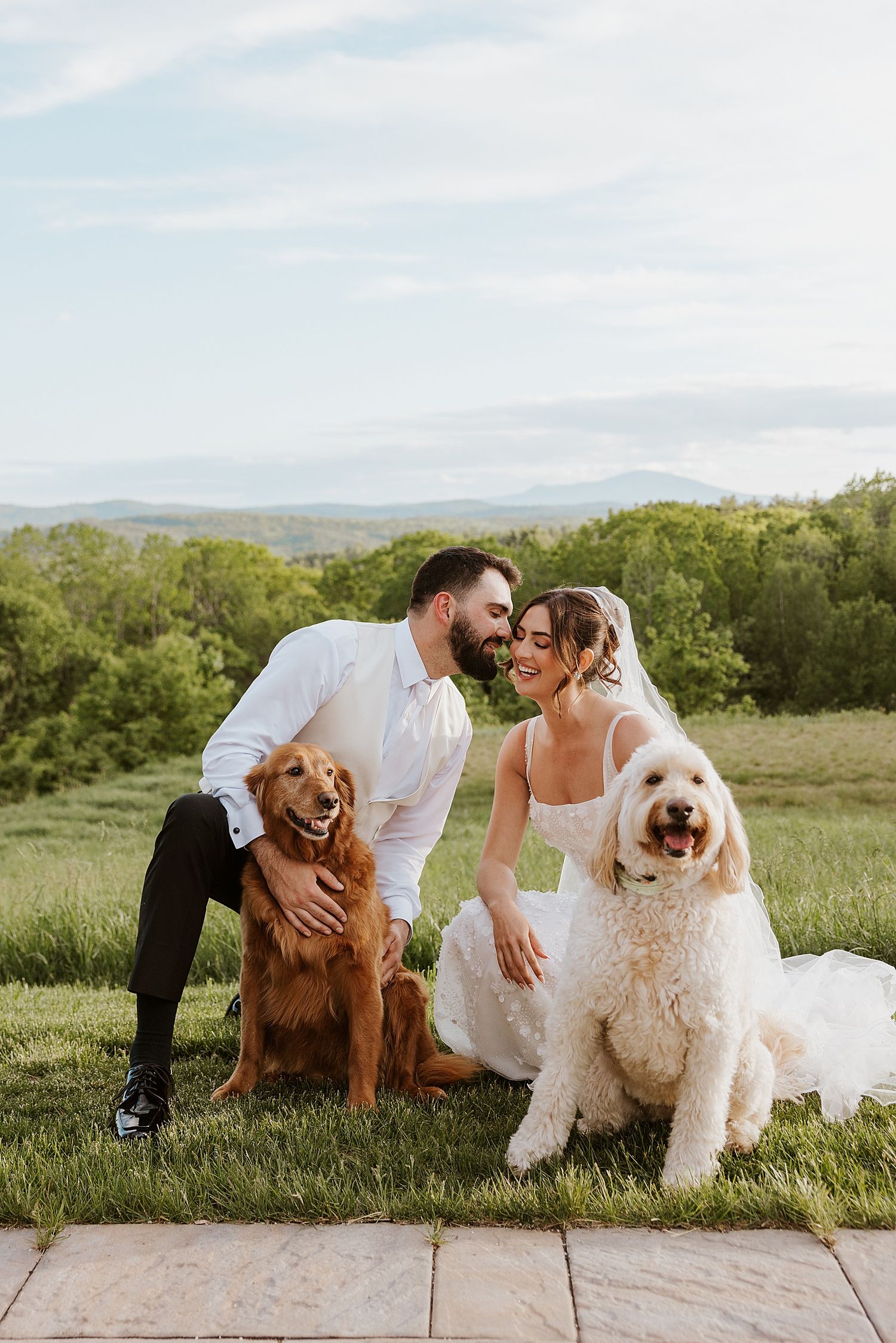 Bride and groom taking portraits with their dogs at their NH wedding