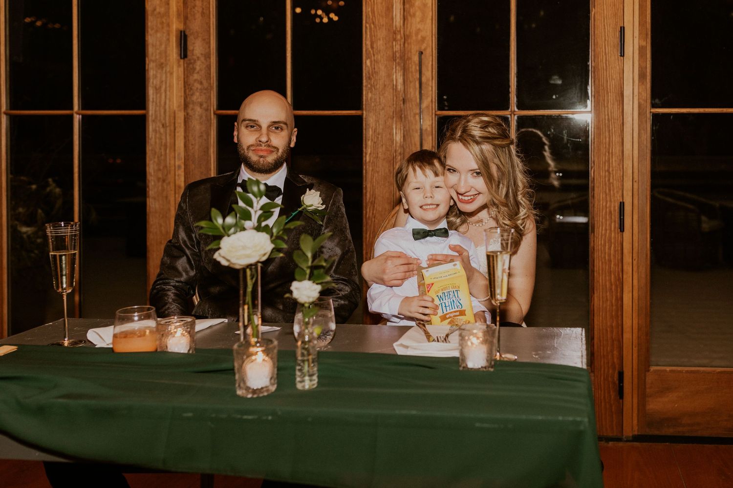 Deirdre and Brodie sitting together during toasts, their nephew Colby was sitting on Deirdre's lap.