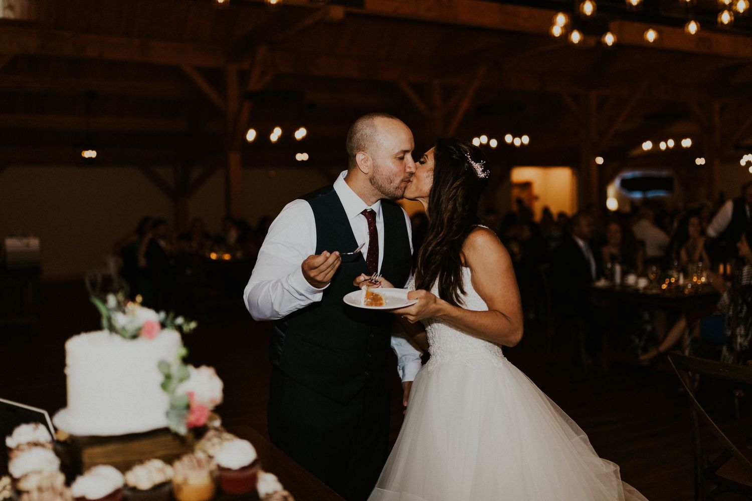Wedding guests dancing and celebrating during an evening reception.