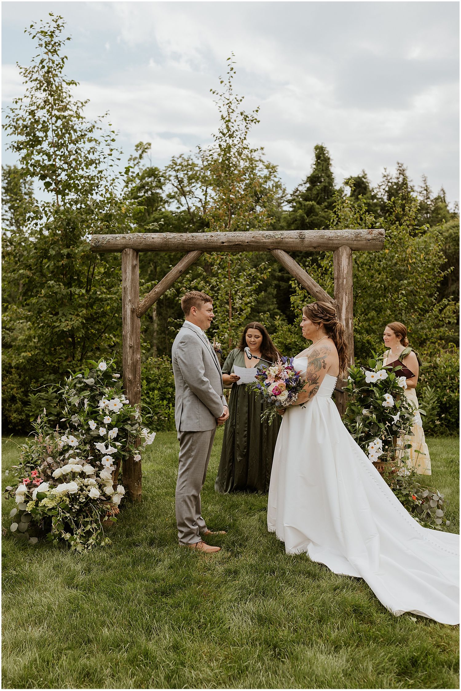 Couple at their wedding ceremony at the outdoor wedding venue in NH Locke Falls Farm