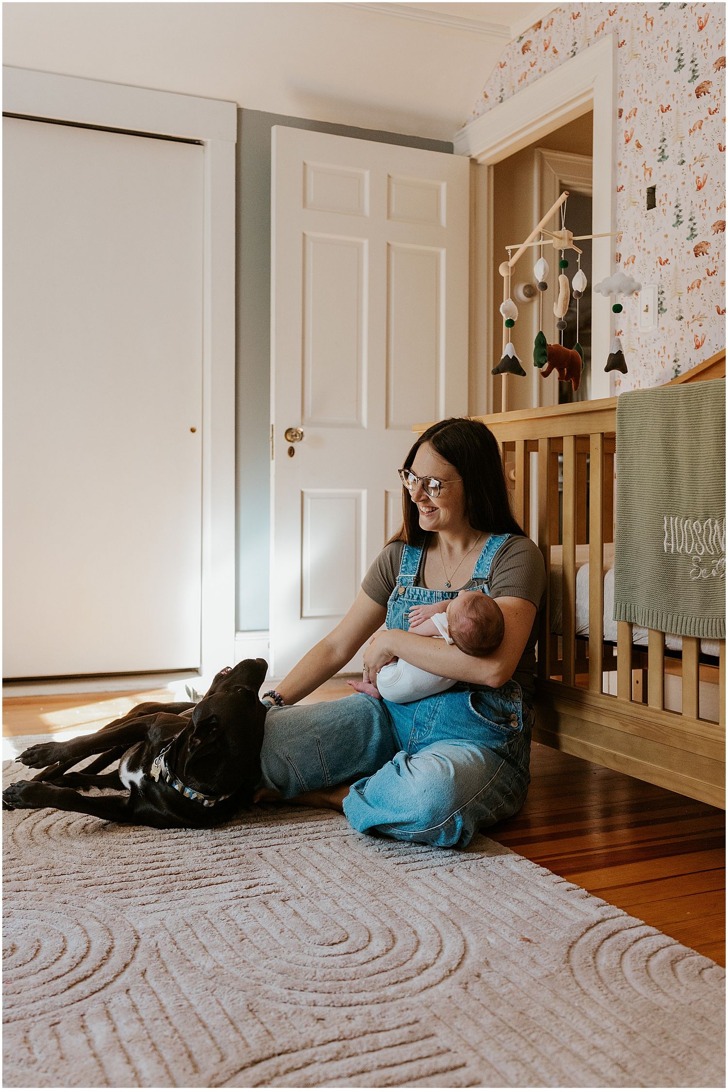 New Hampshire mom taking newborn family photos at home with her new baby and her dog