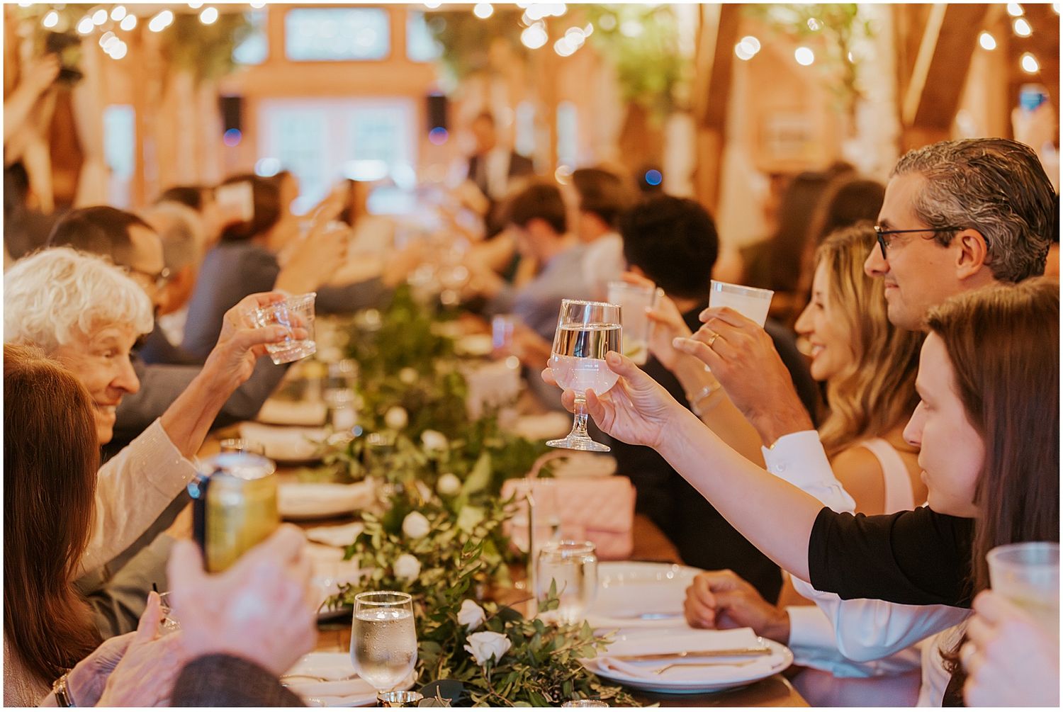 Wedding guests toasting at a NH wedding