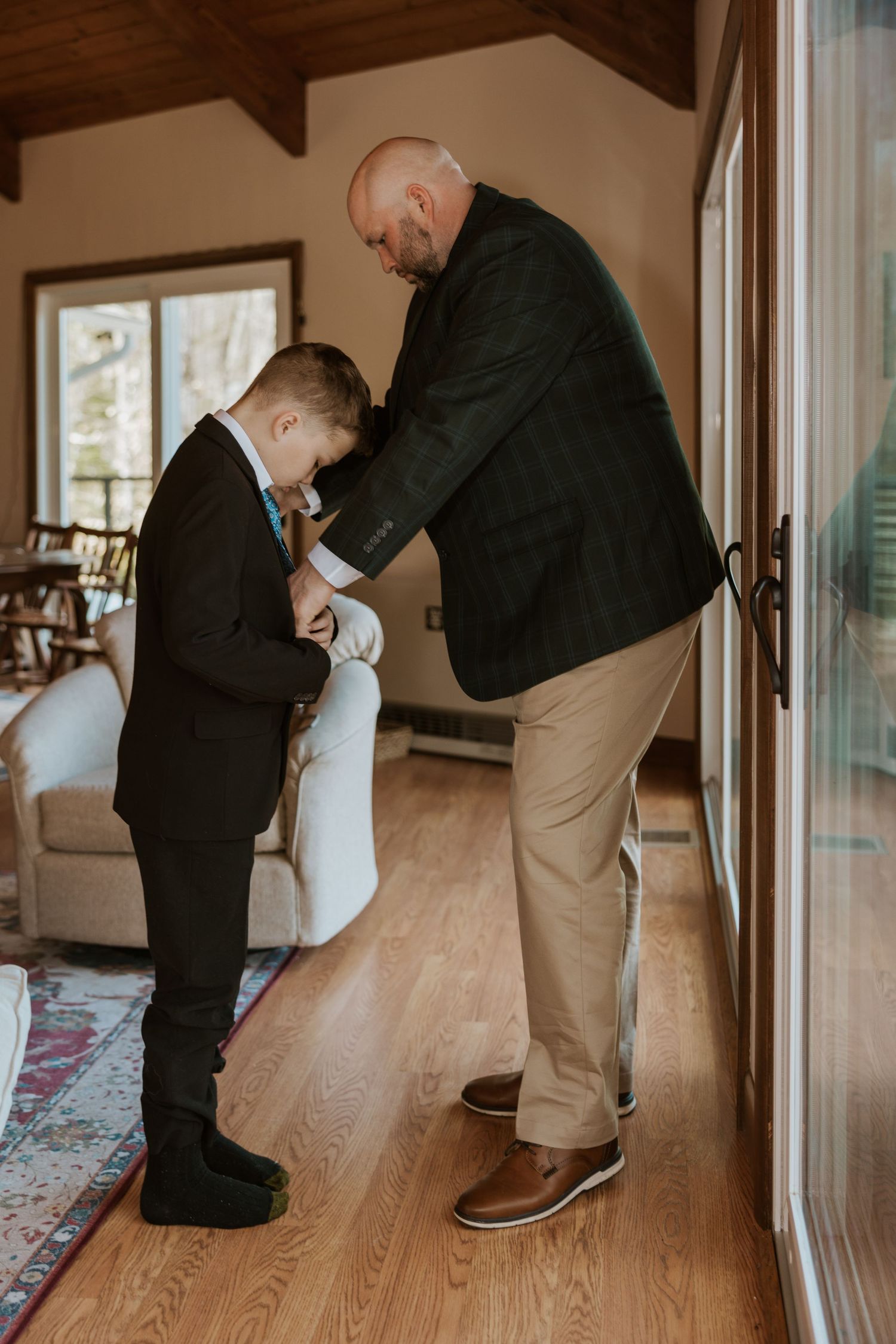 A series of getting ready photos showing someone putting on dress shoes in an indoor setting.