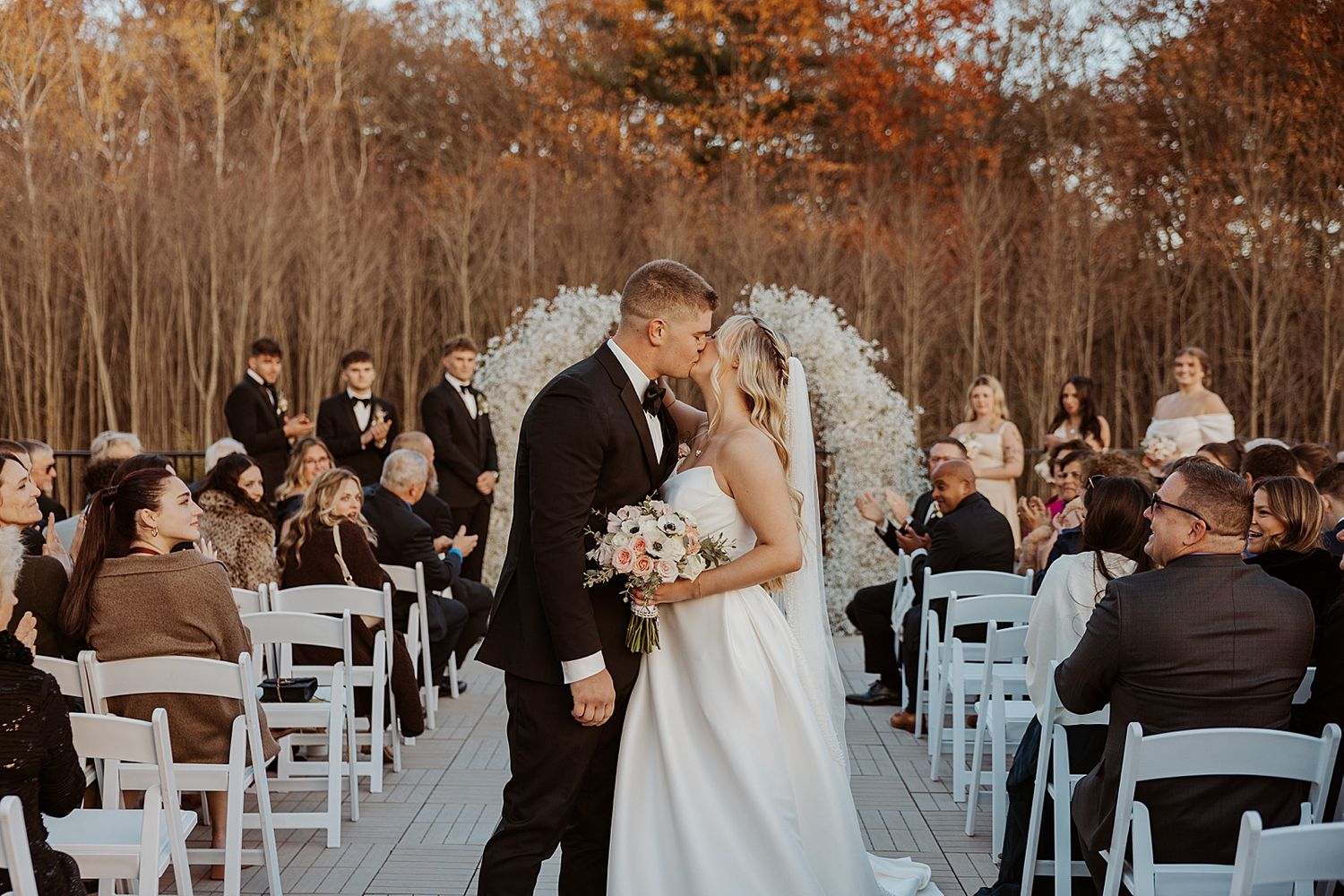Bride and groom kissing at their Hyla Brook Estate wedding ceremony in NH