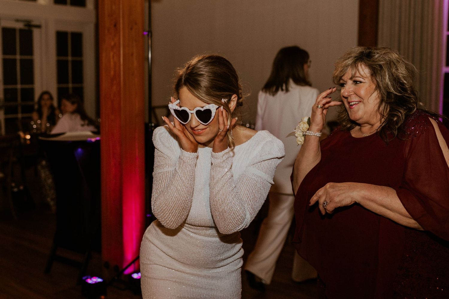 The bride dancing and enjoying the night with her sunglasses and glamorous reception dress!