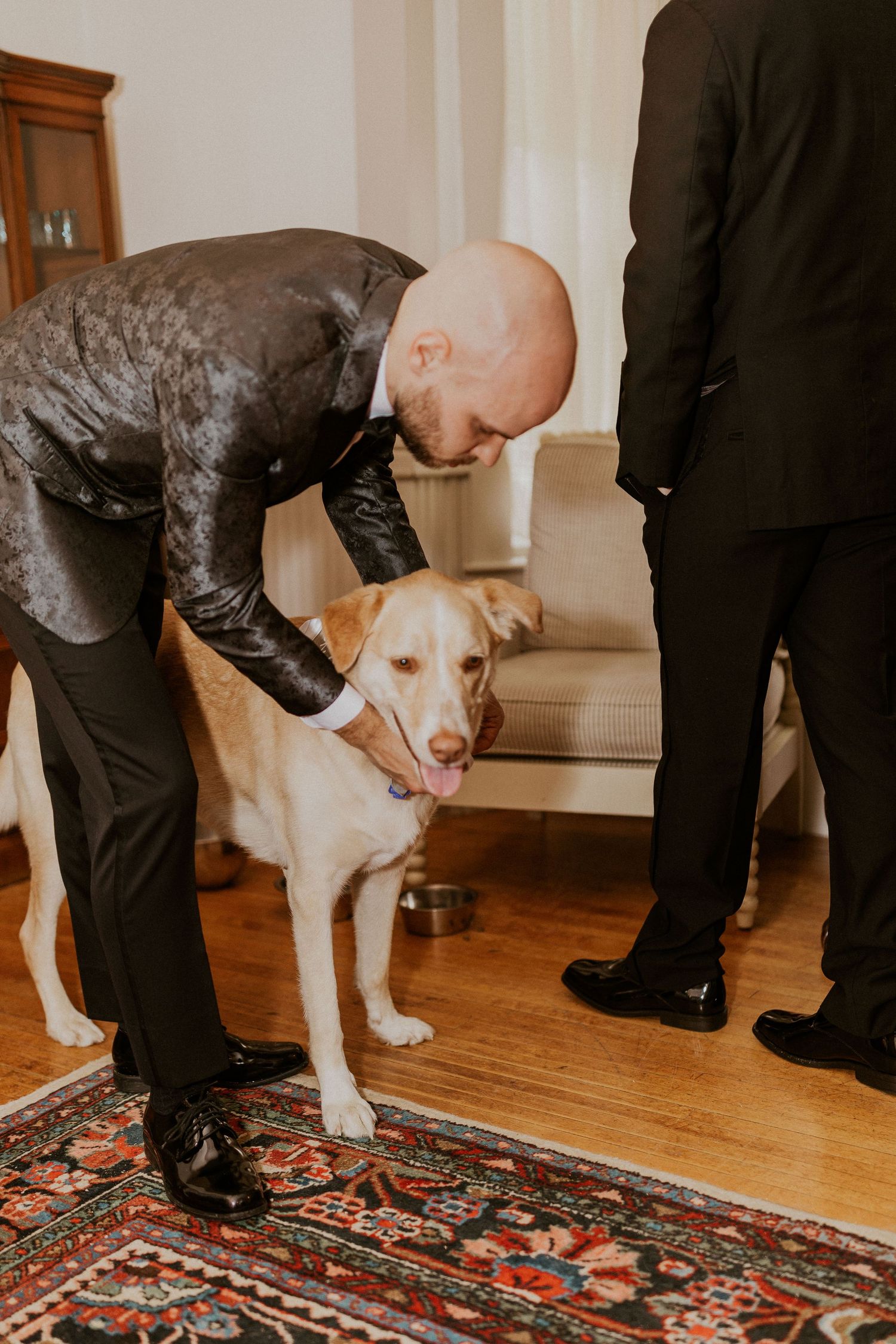 Brodie petting Kenobi before the start of the wedding ceremony.
