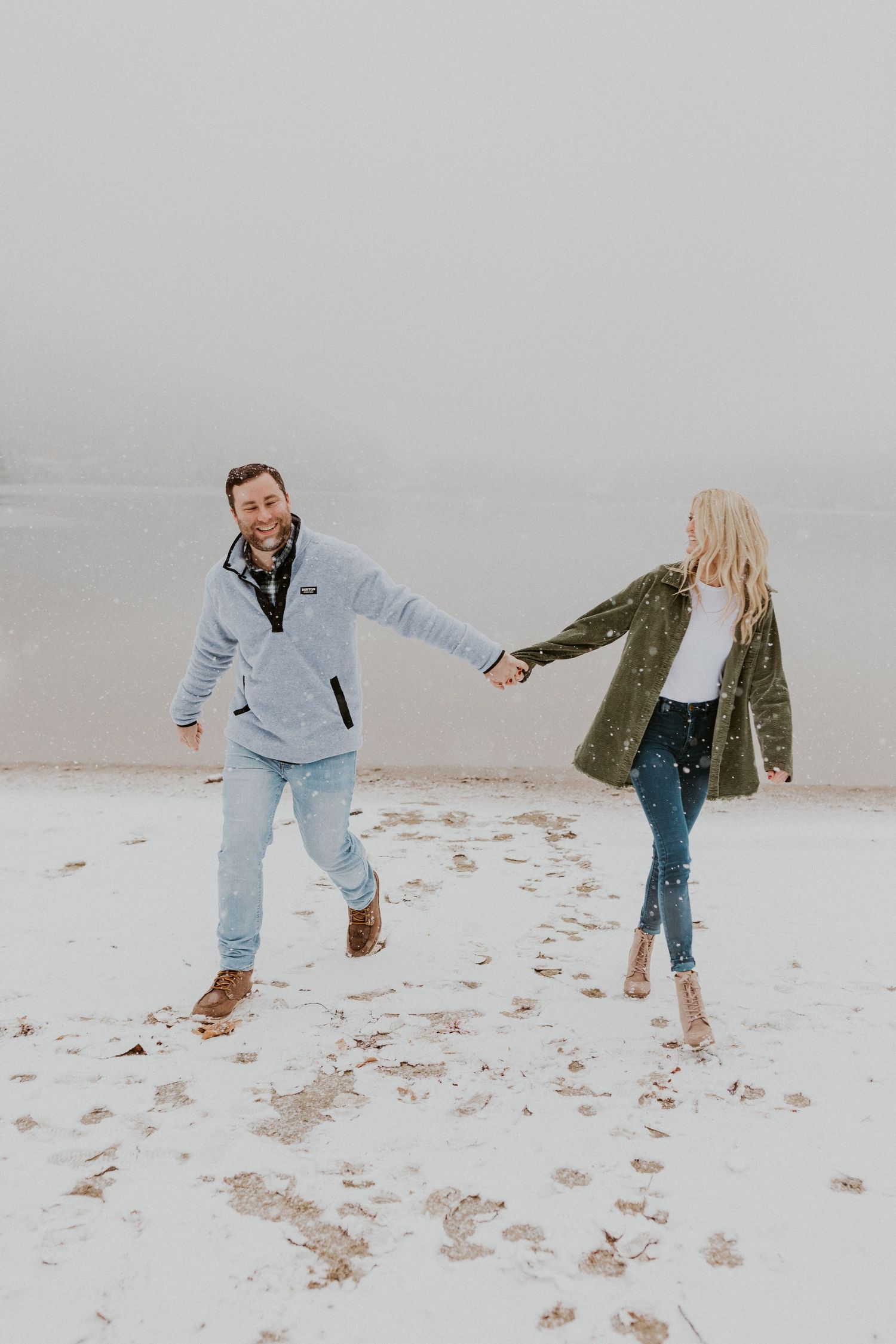 Newly engaged couple playfully posing for photos during their engagement session in Franconia New Hampshire.