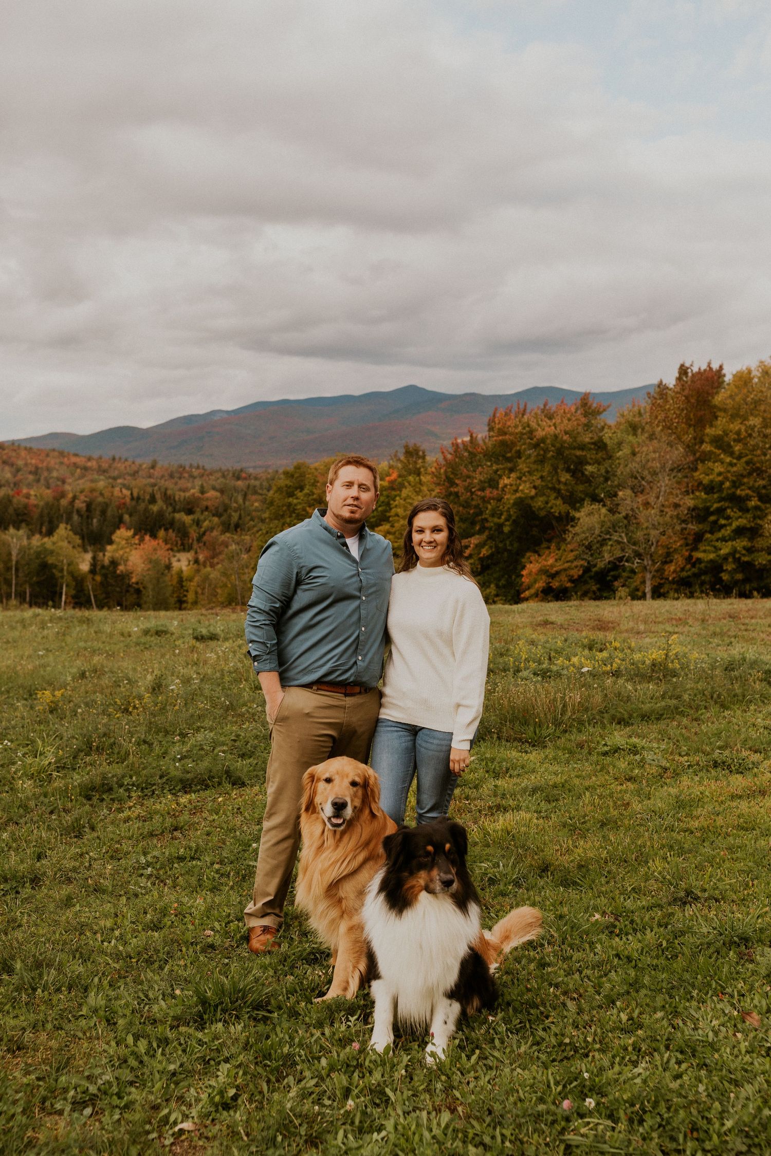 Paige and Michael posing for a portrait with their dogs in the twin mountain region of New Hampshire.