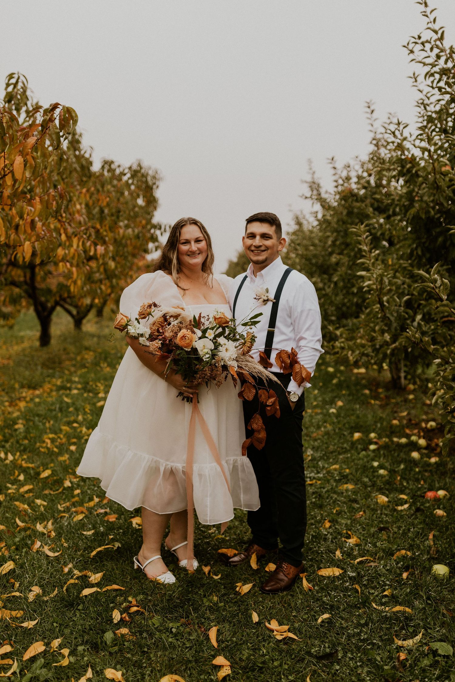 Terise and Jose smiling for a portrait after their wedding ceremony at Carter Hill Orchard in Concord New Hampshire.