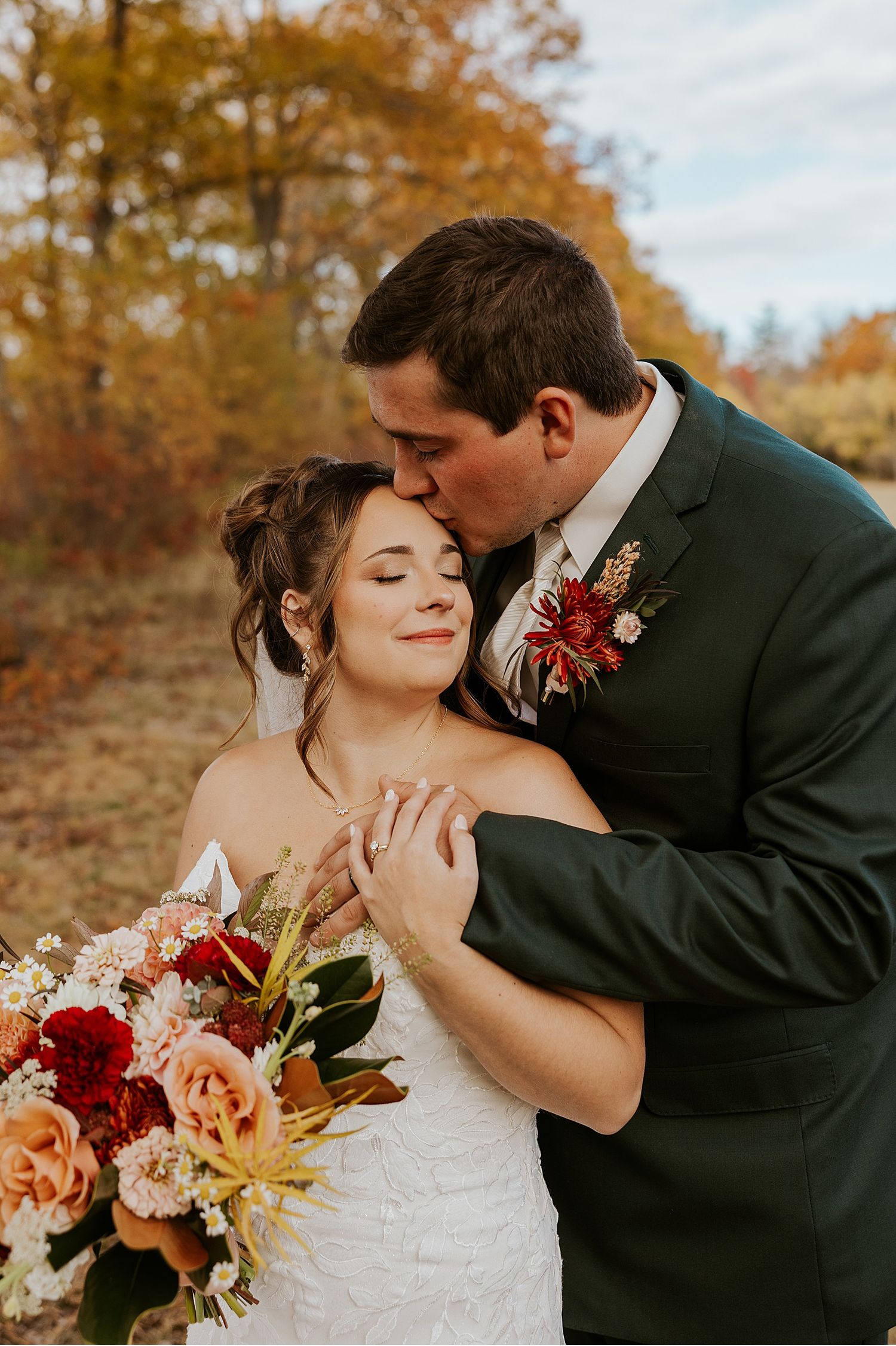 Bride and groom taking portraits at their fall wedding in Maine