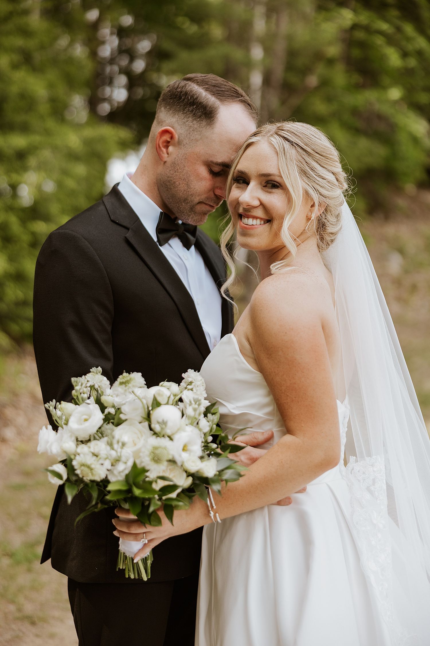 Bride and groom taking portrait photos at their Owl's Nest Resort wedding in NH