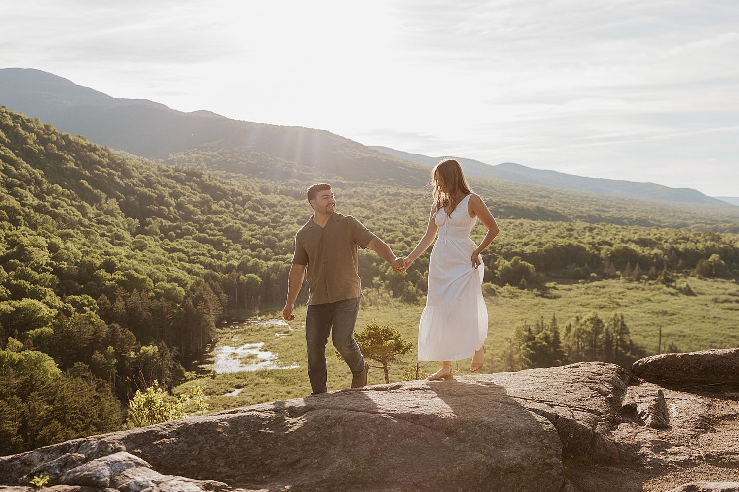 Couple taking golden hour engagement photos in the White Mountains in NH