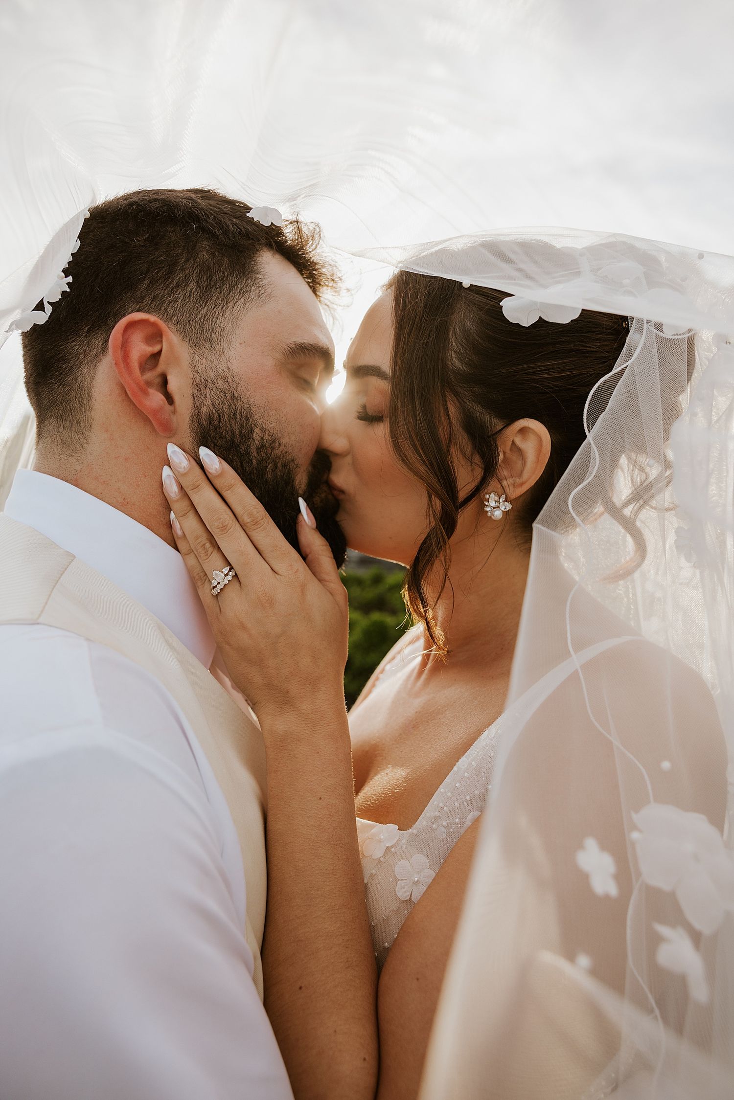 Bride and groom taking wedding veil photos at their NH wedding