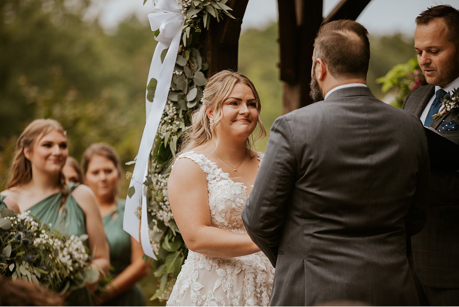 Joyful moments during an outdoor wedding ceremony with natural greenery backdrop.