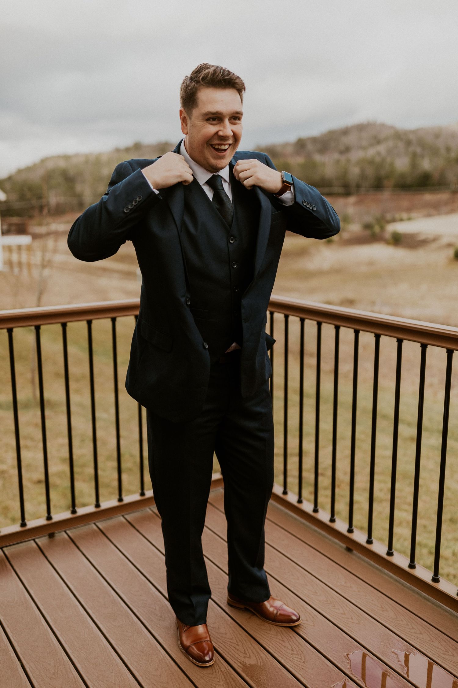 Keegan, the groom, putting his final touches on and straightening his tie.