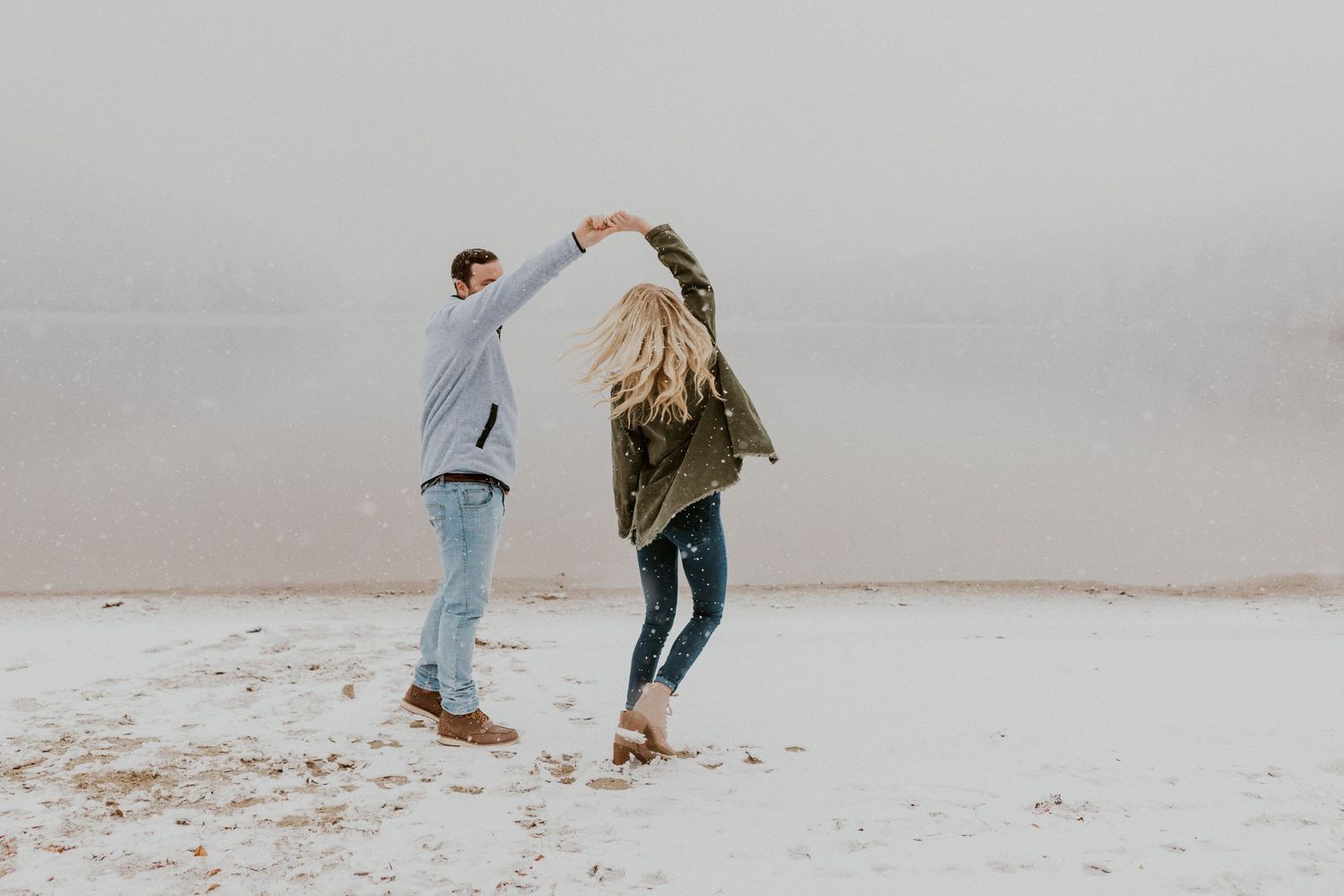 Newly engaged couple playfully posing for photos during their engagement session in Franconia New Hampshire.